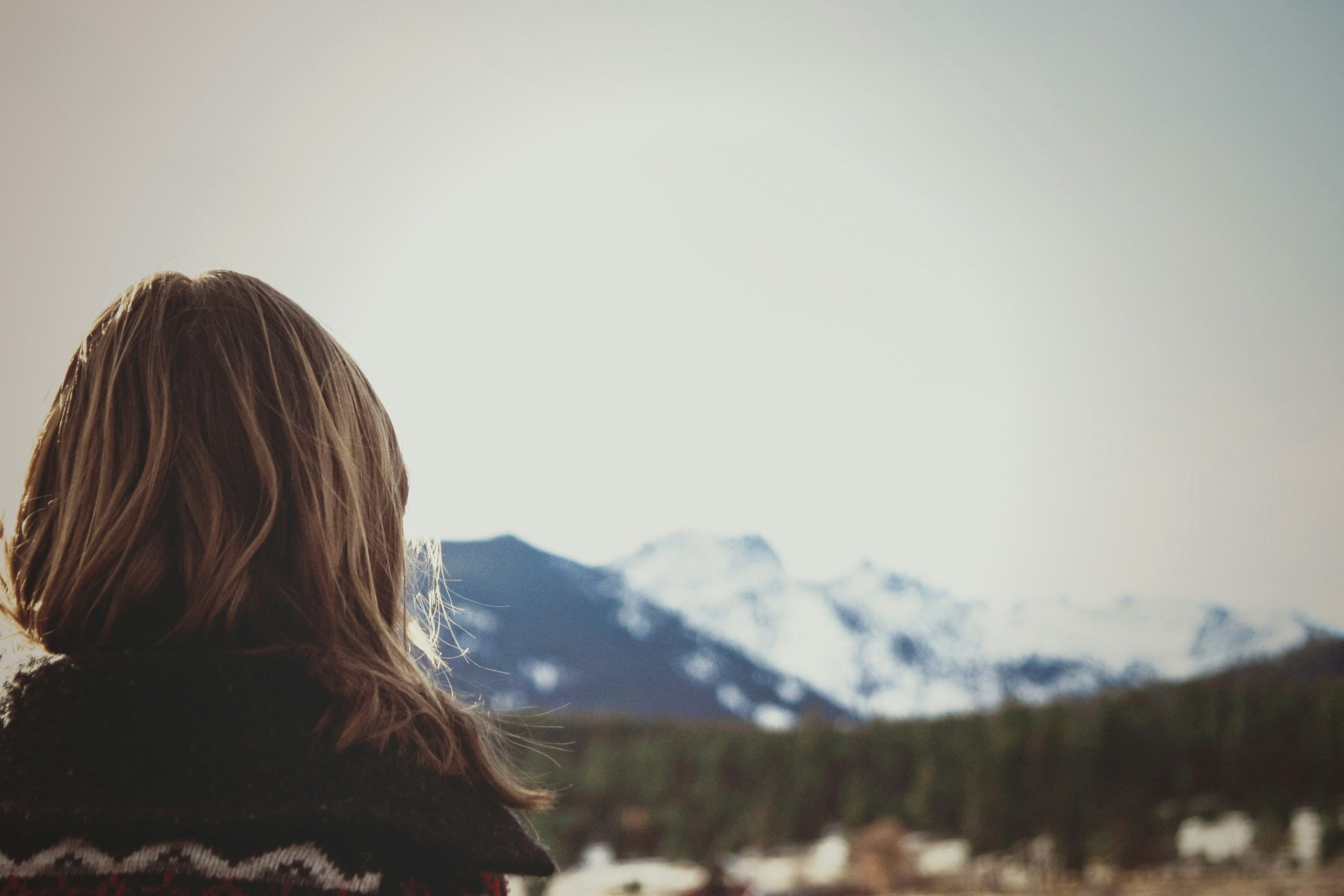 Woman Gazing at Snow Capped Mountains