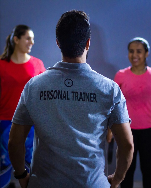 Personal Trainer With Trainees in Gym
