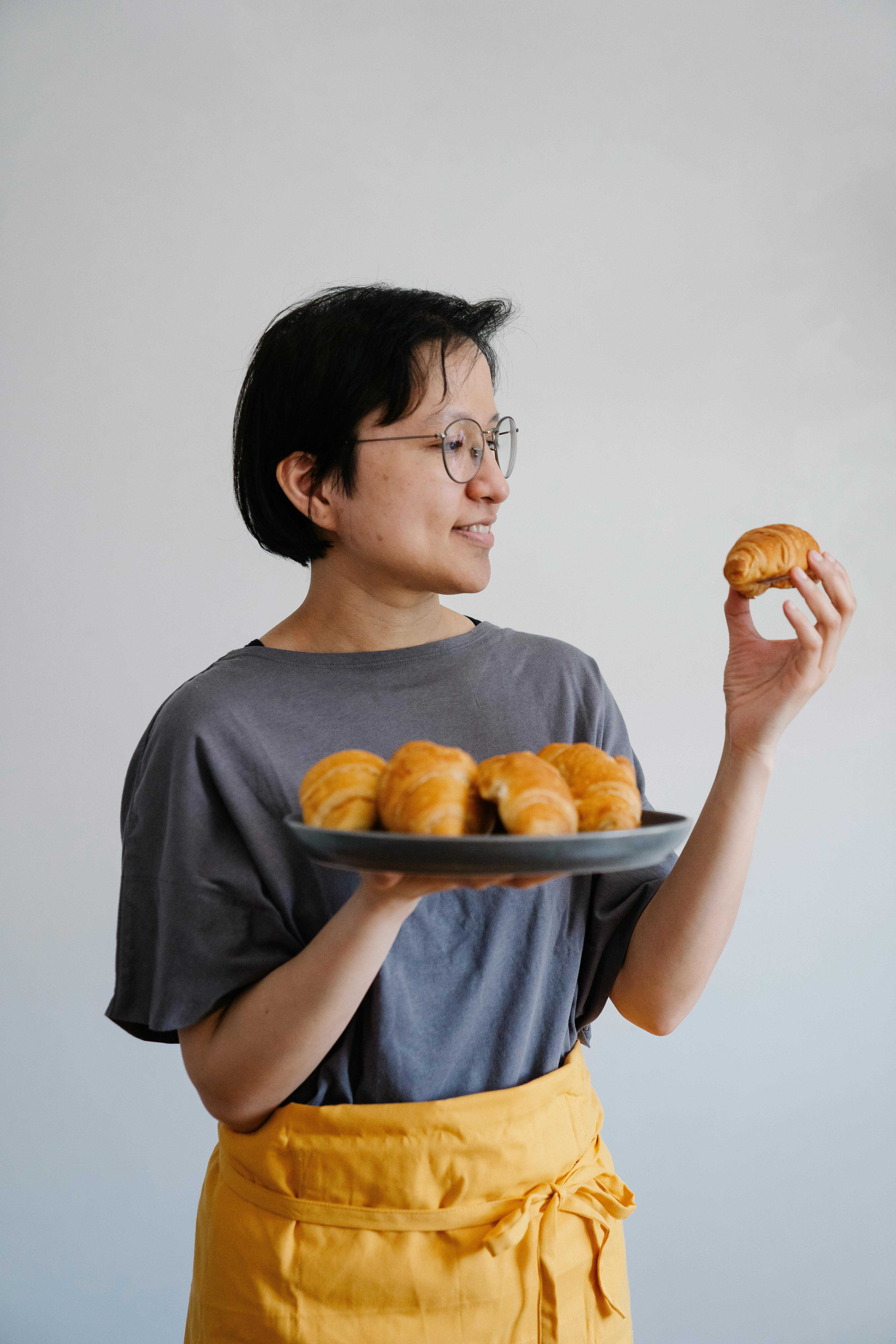 Woman Holding Fresh Baked Croissants