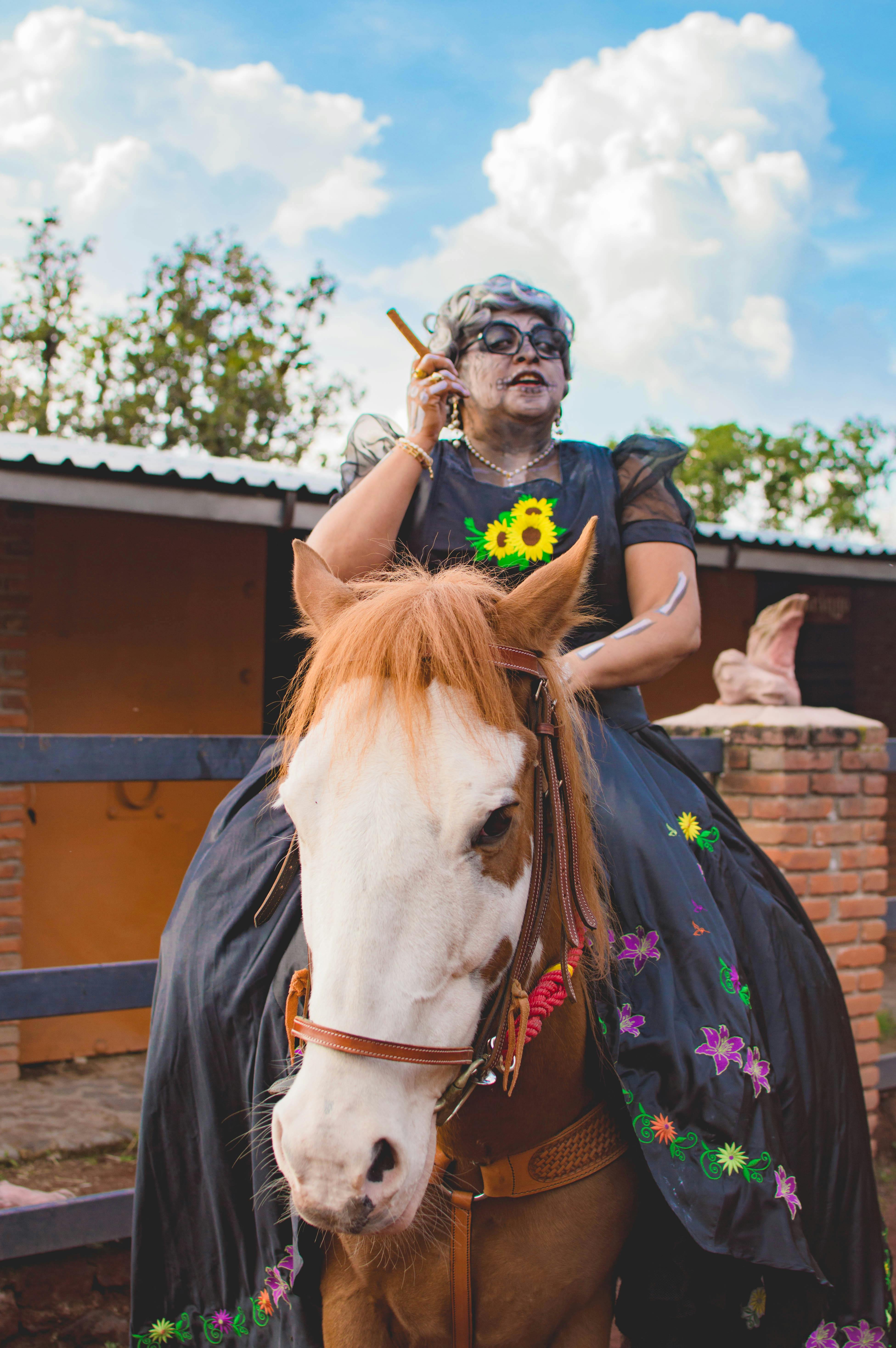 Costumed Person Riding Horse At Stable