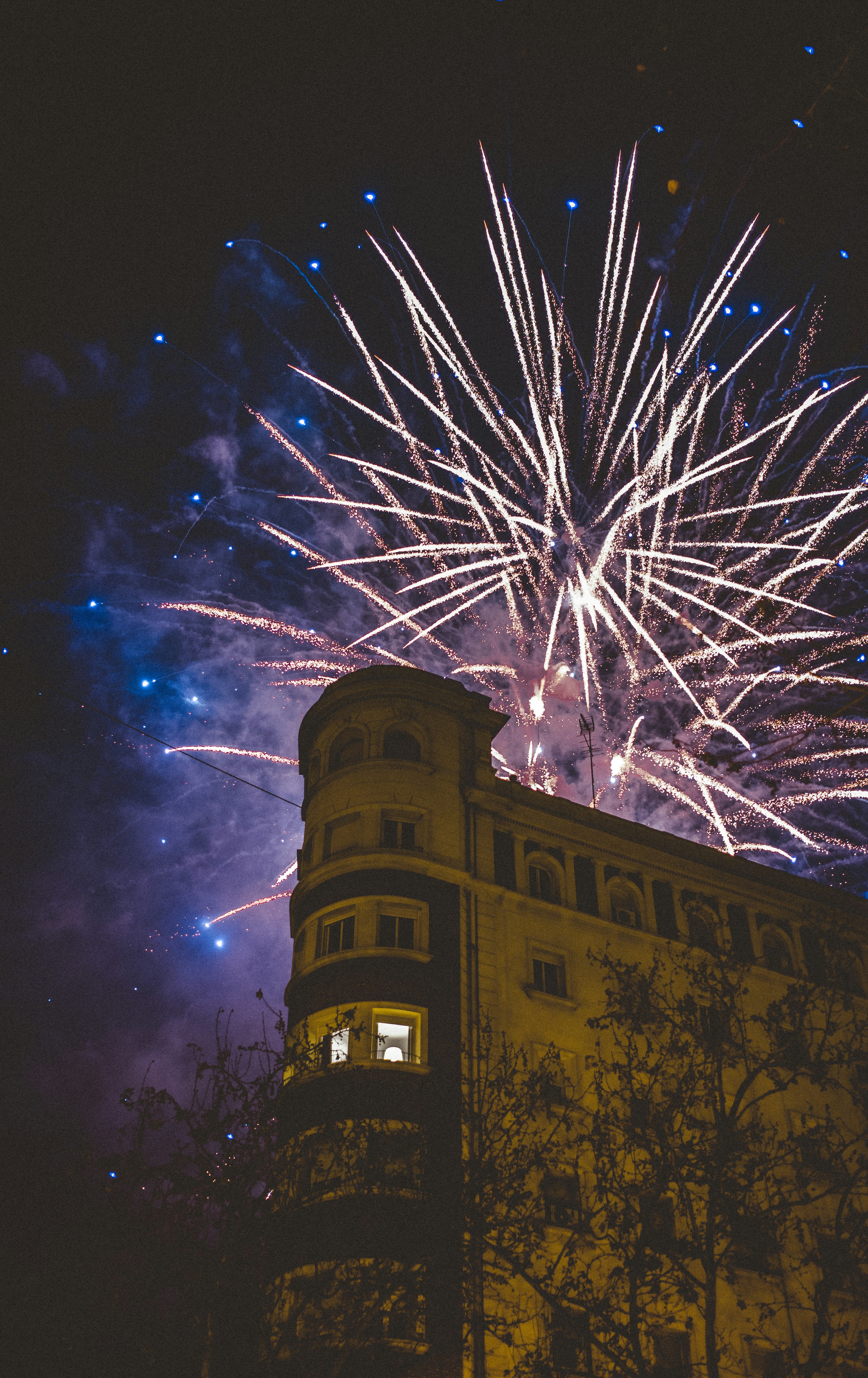 Fireworks Over Urban Building at Night