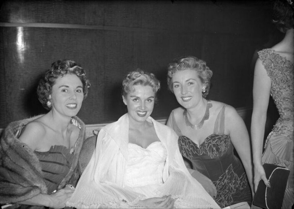 Three Smiling Women at Formal Event