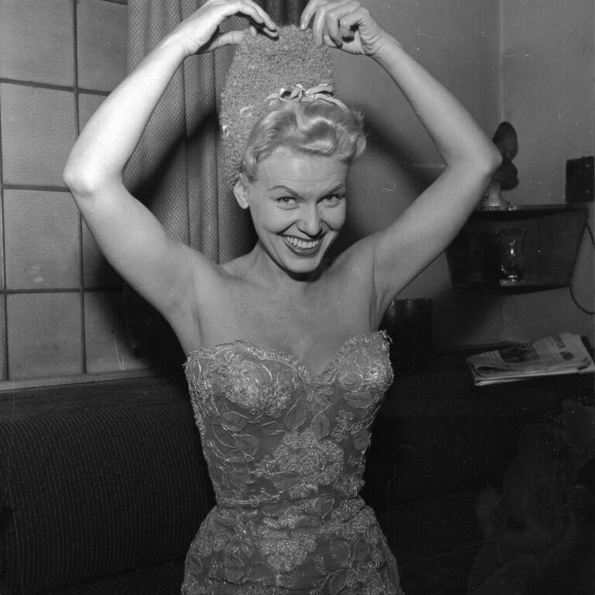 Smiling Woman Holding Large Wig
