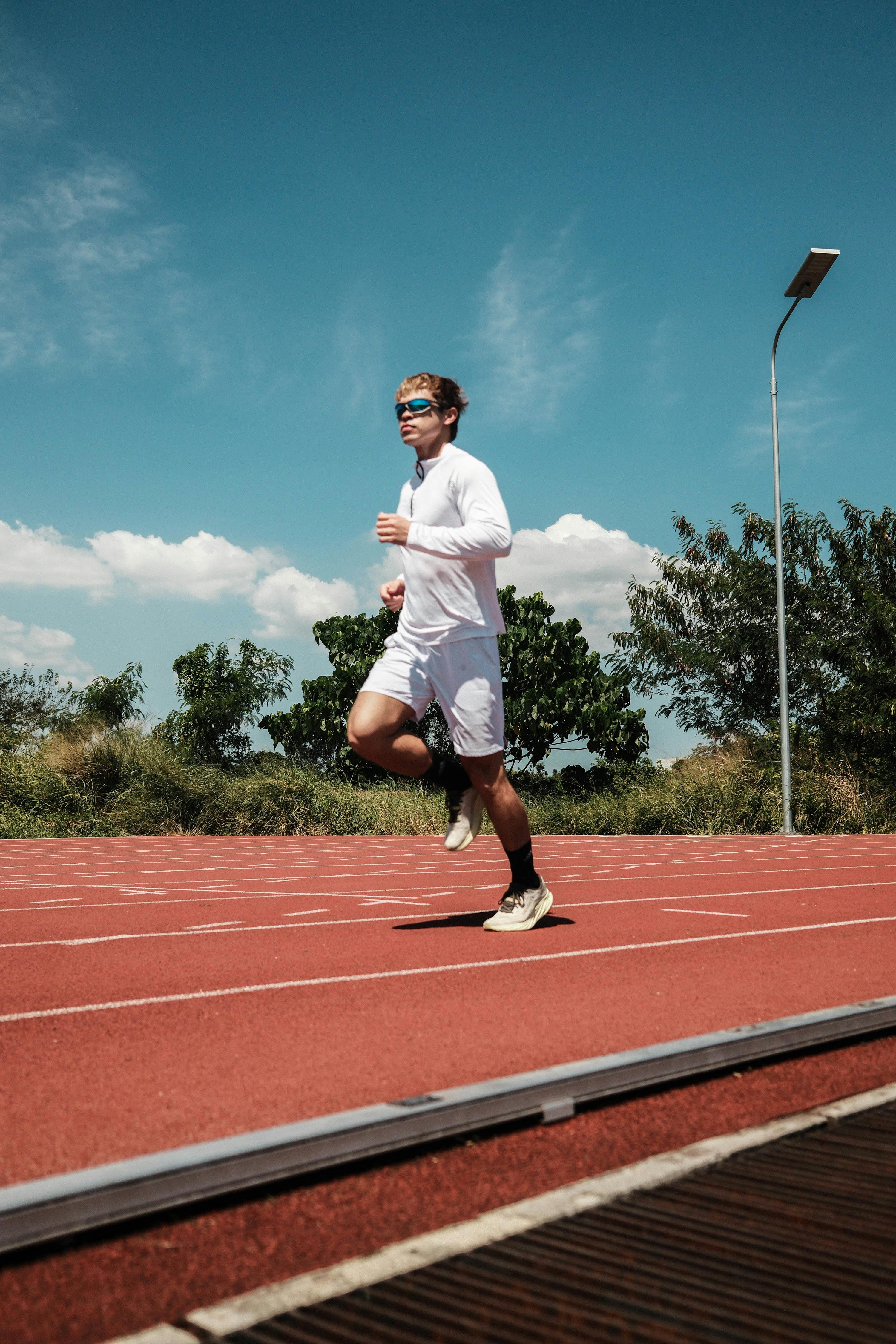 Man Running on Outdoor Running Track