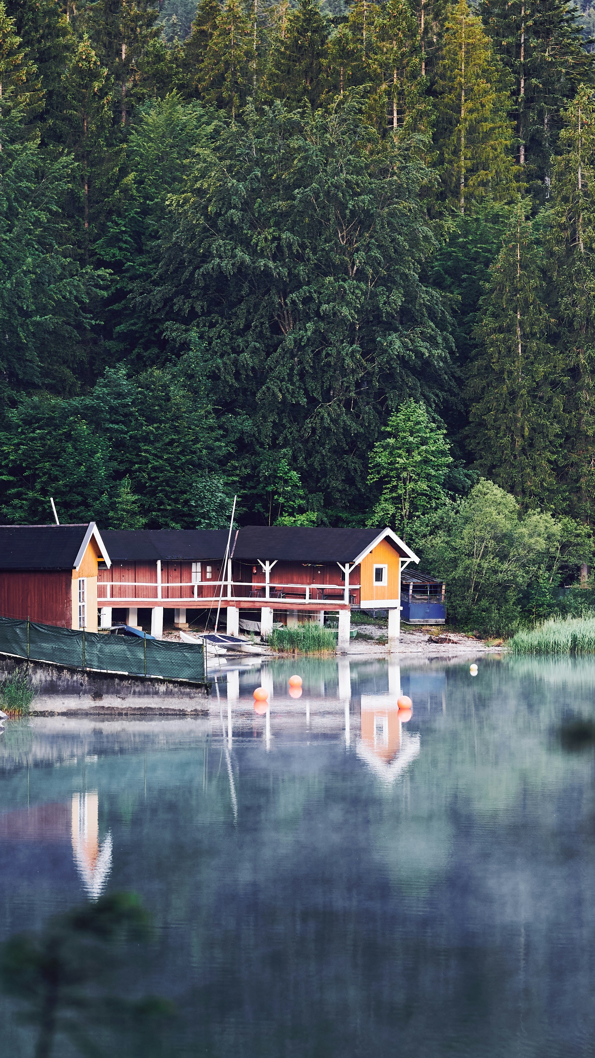 Boathouses on Calm Forest Lake