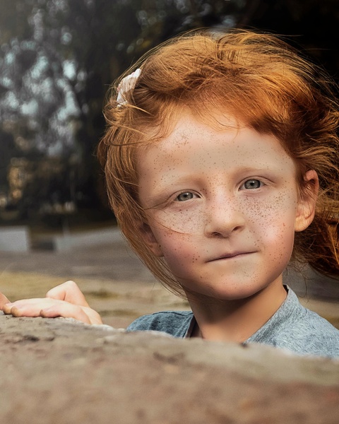 Freckled Red-haired Girl Peeking Over Wall