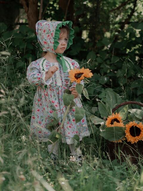 Toddler Girl With Sunflowers In Garden