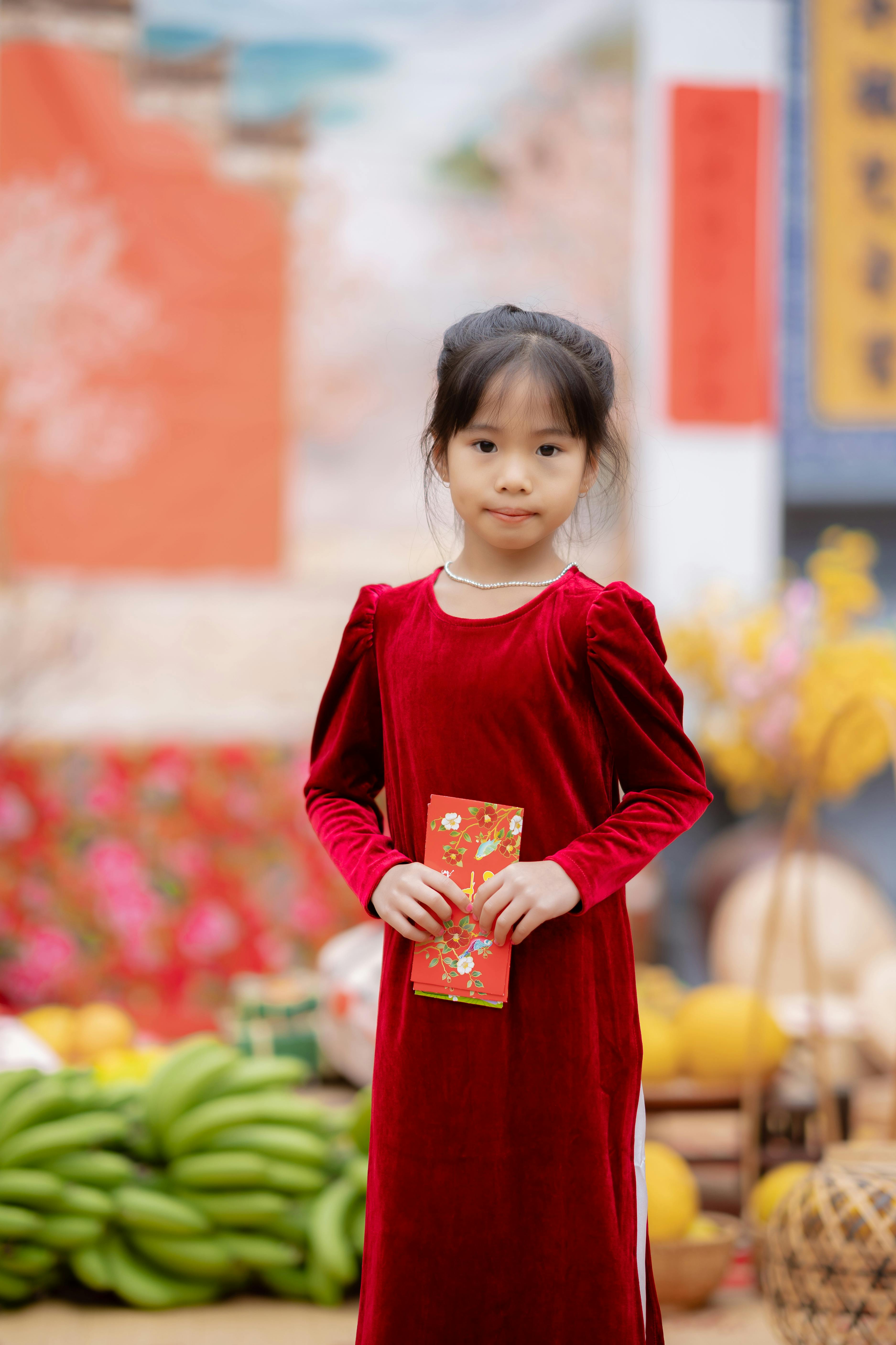 Young Girl Holding Red Envelope