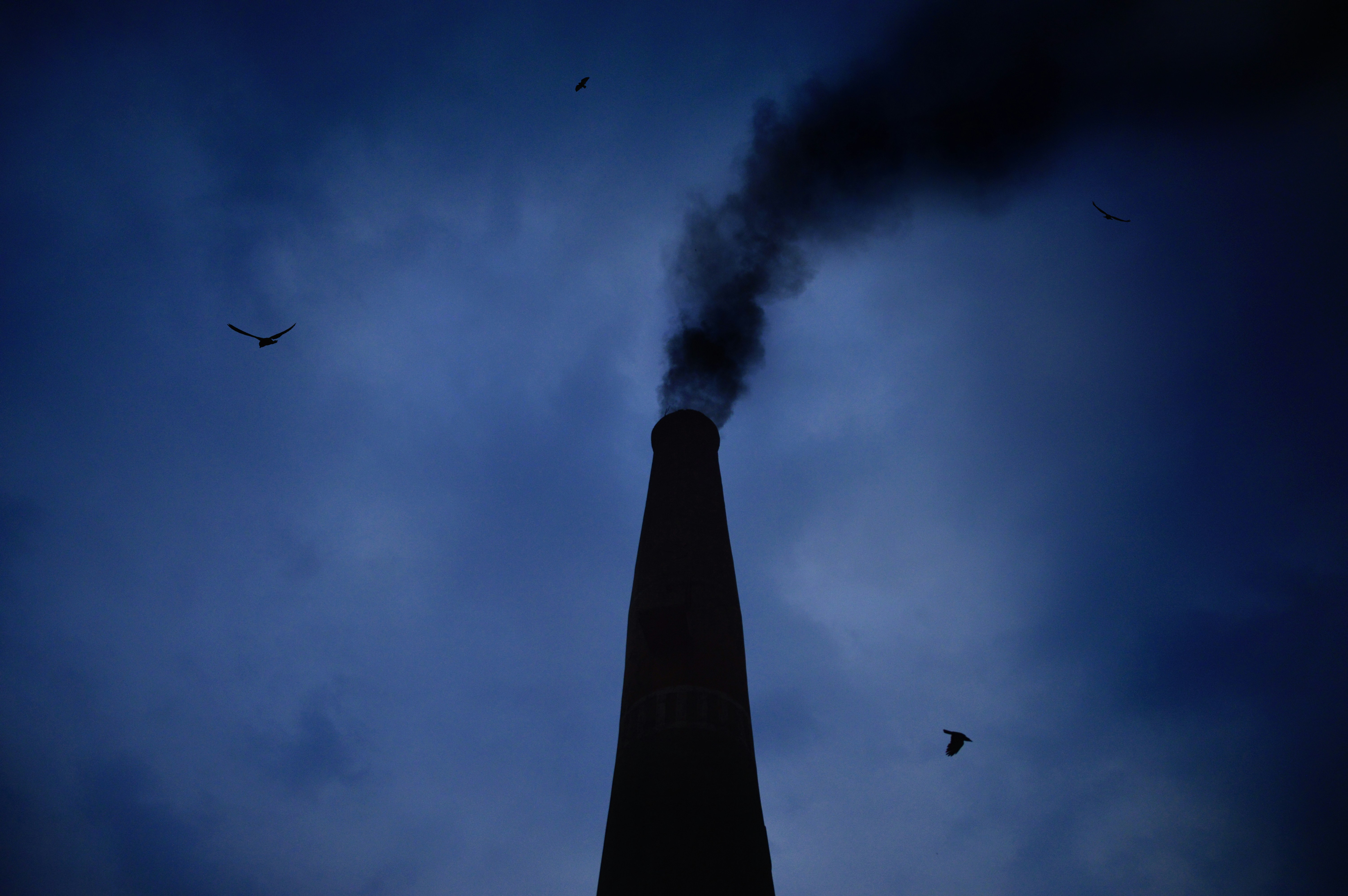 Smoking Chimney Silhouette at Dusk