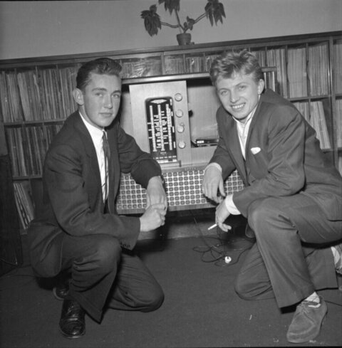Two Men Posing By Vintage Radio