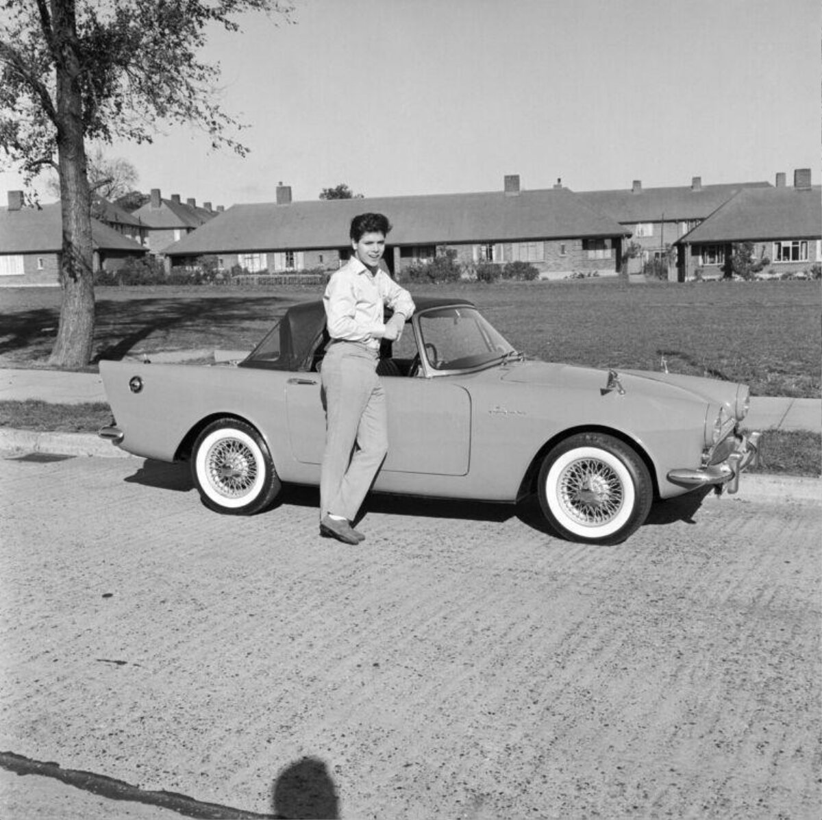 Man Leaning On Vintage Convertible Car