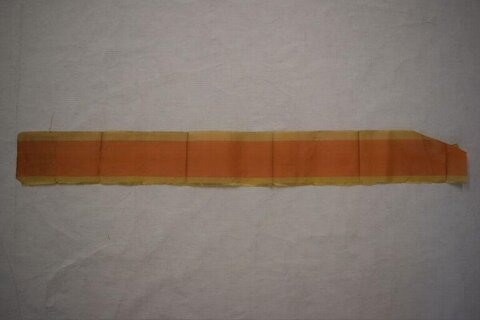 Folded Orange Paper Strip on White Background