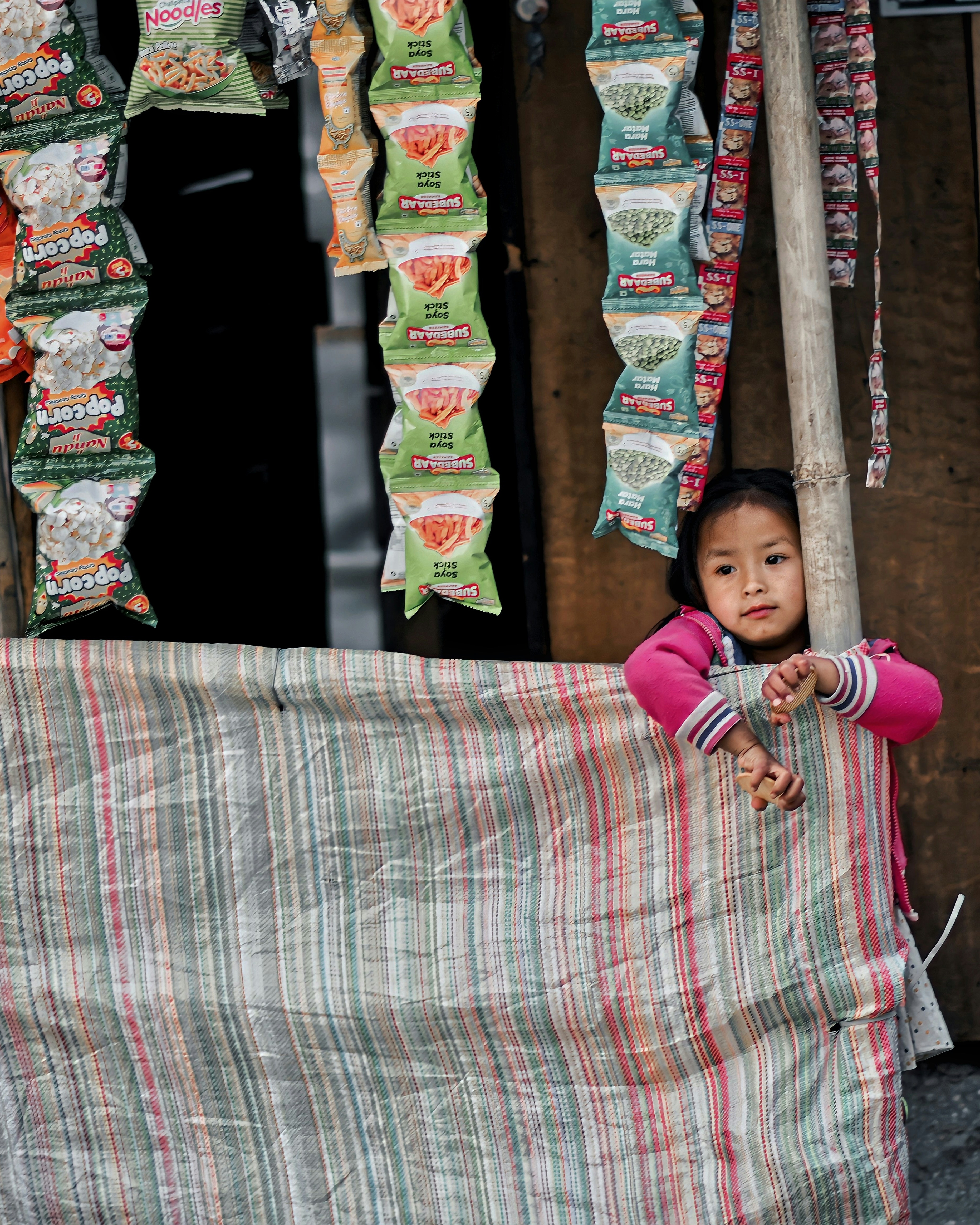 Little Girl Peeking From Snack Stall
