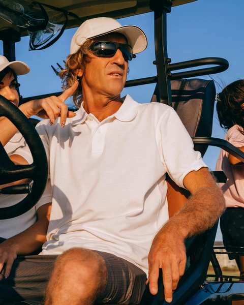 Man Riding in Golf Cart