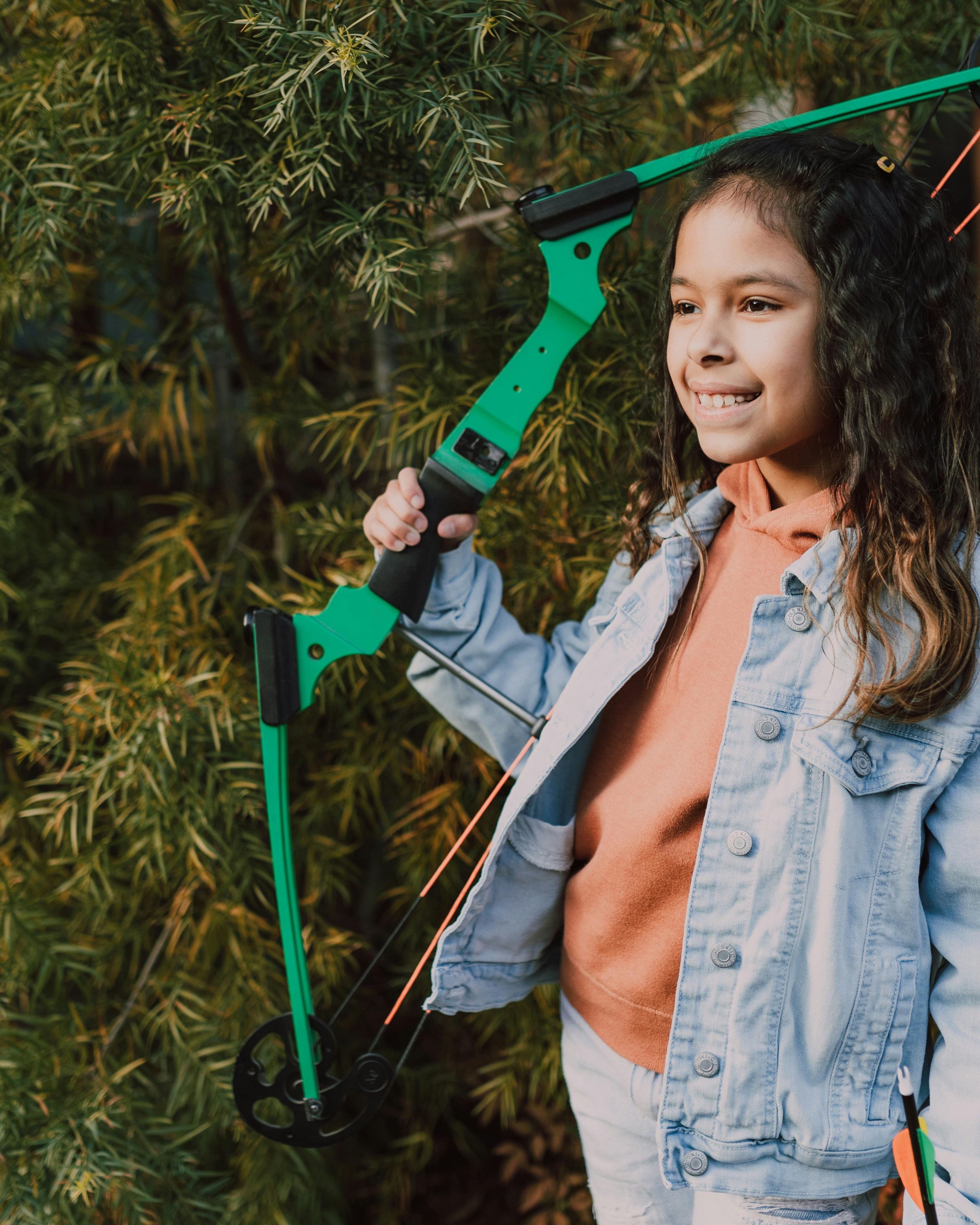 Smiling Girl Holding Youth Archery Bow