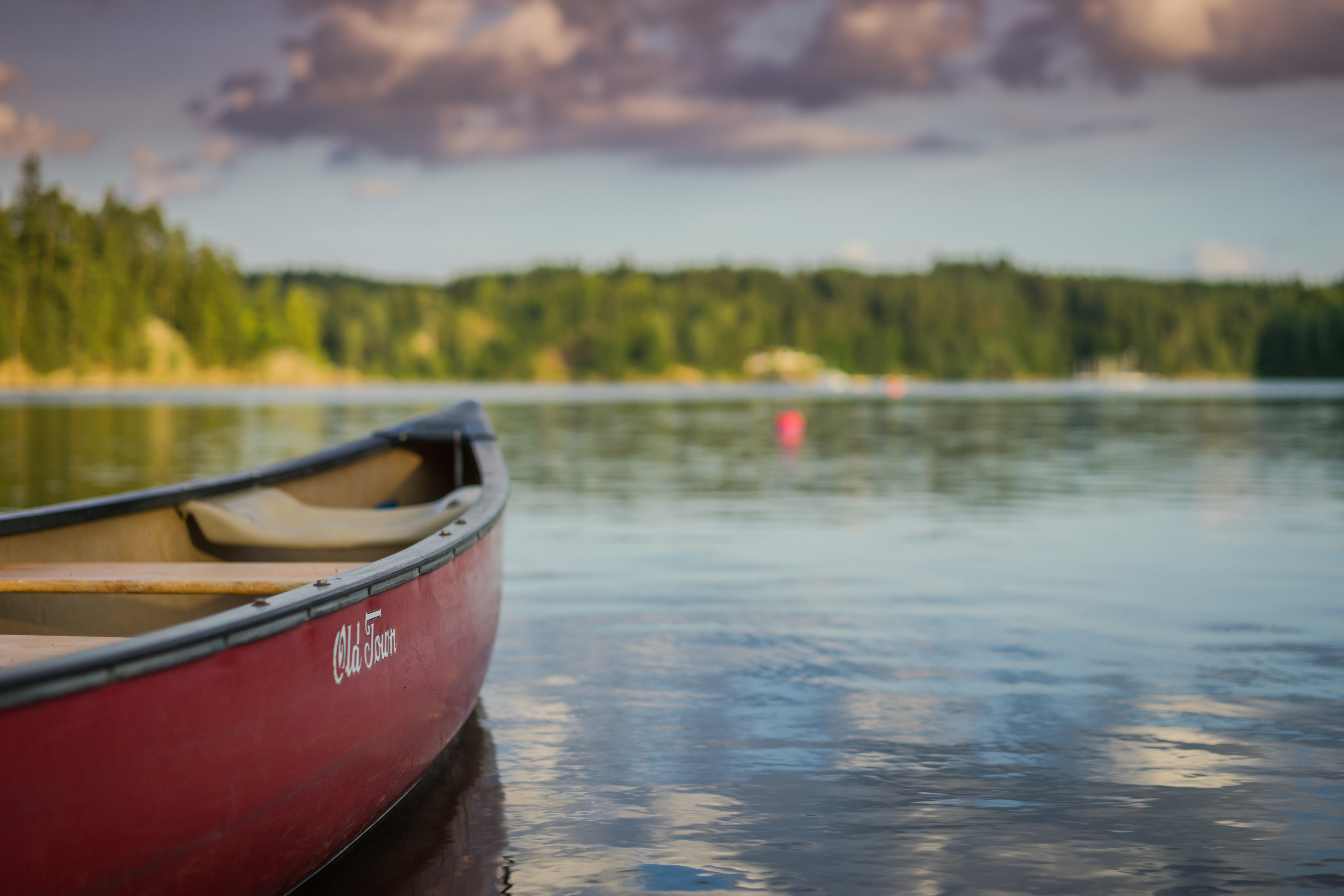 Red Canoe on Calm Lake