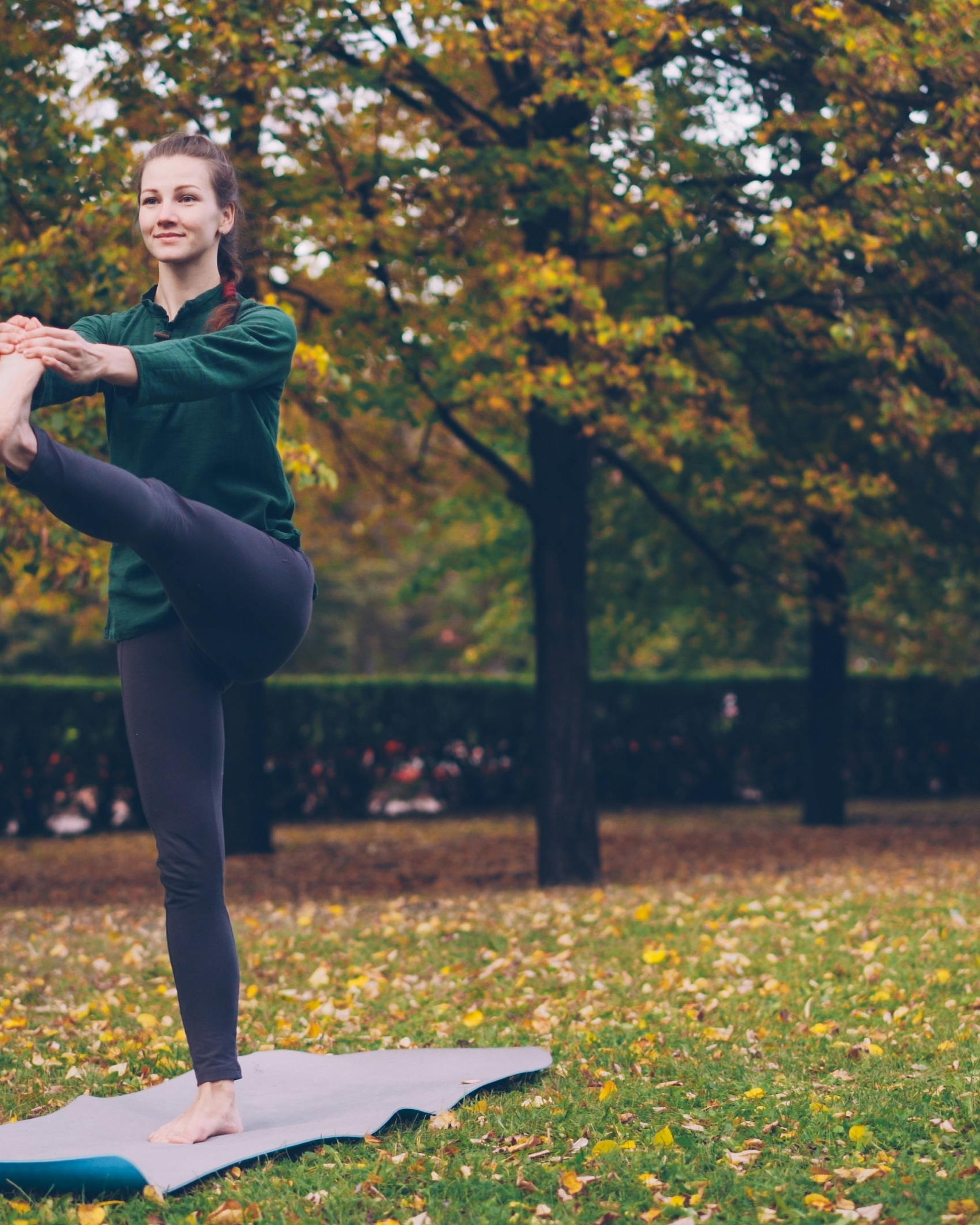 Woman Doing Yoga in Autumn Park