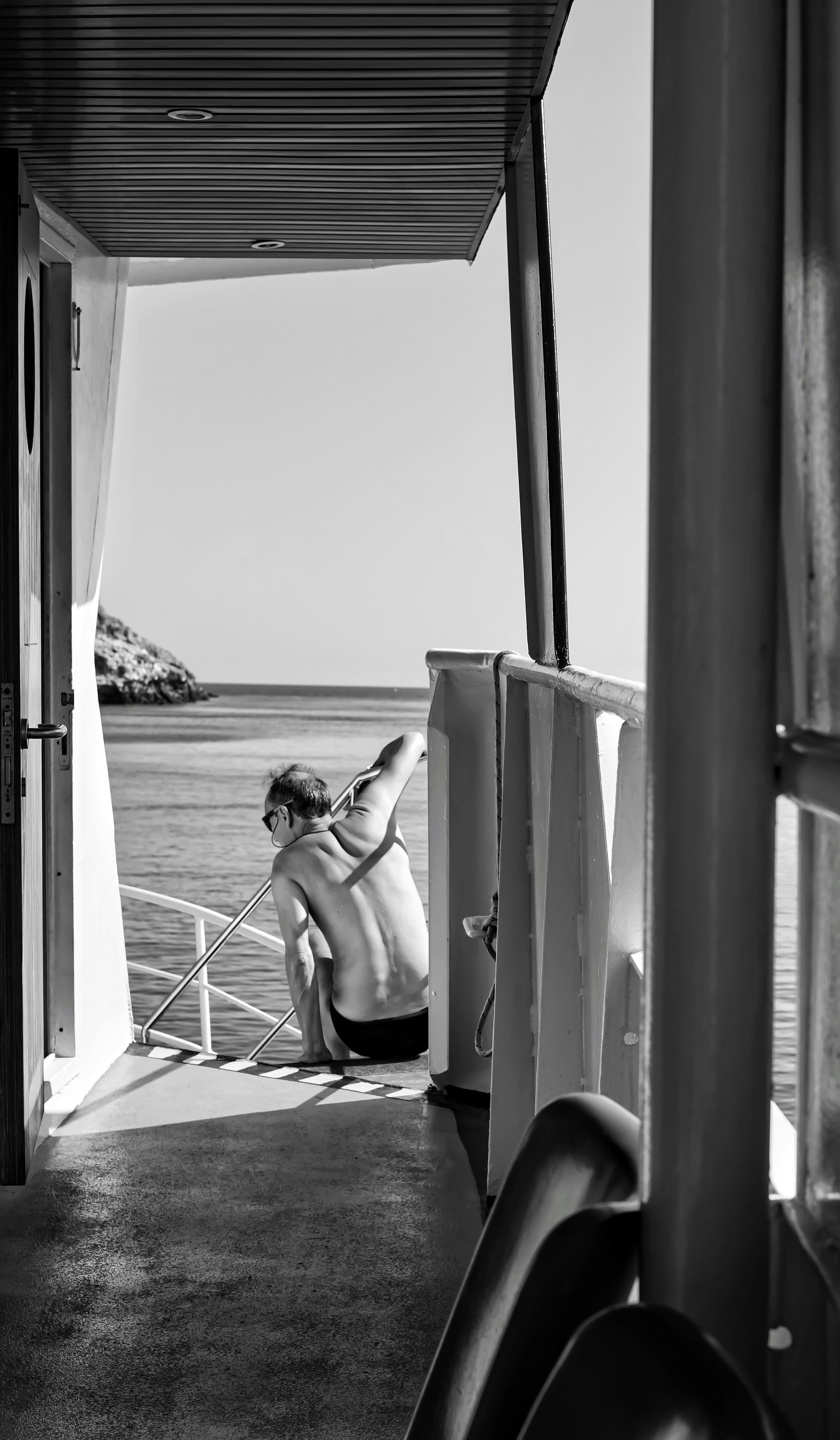 Man Relaxing on Boat Deck by the Sea