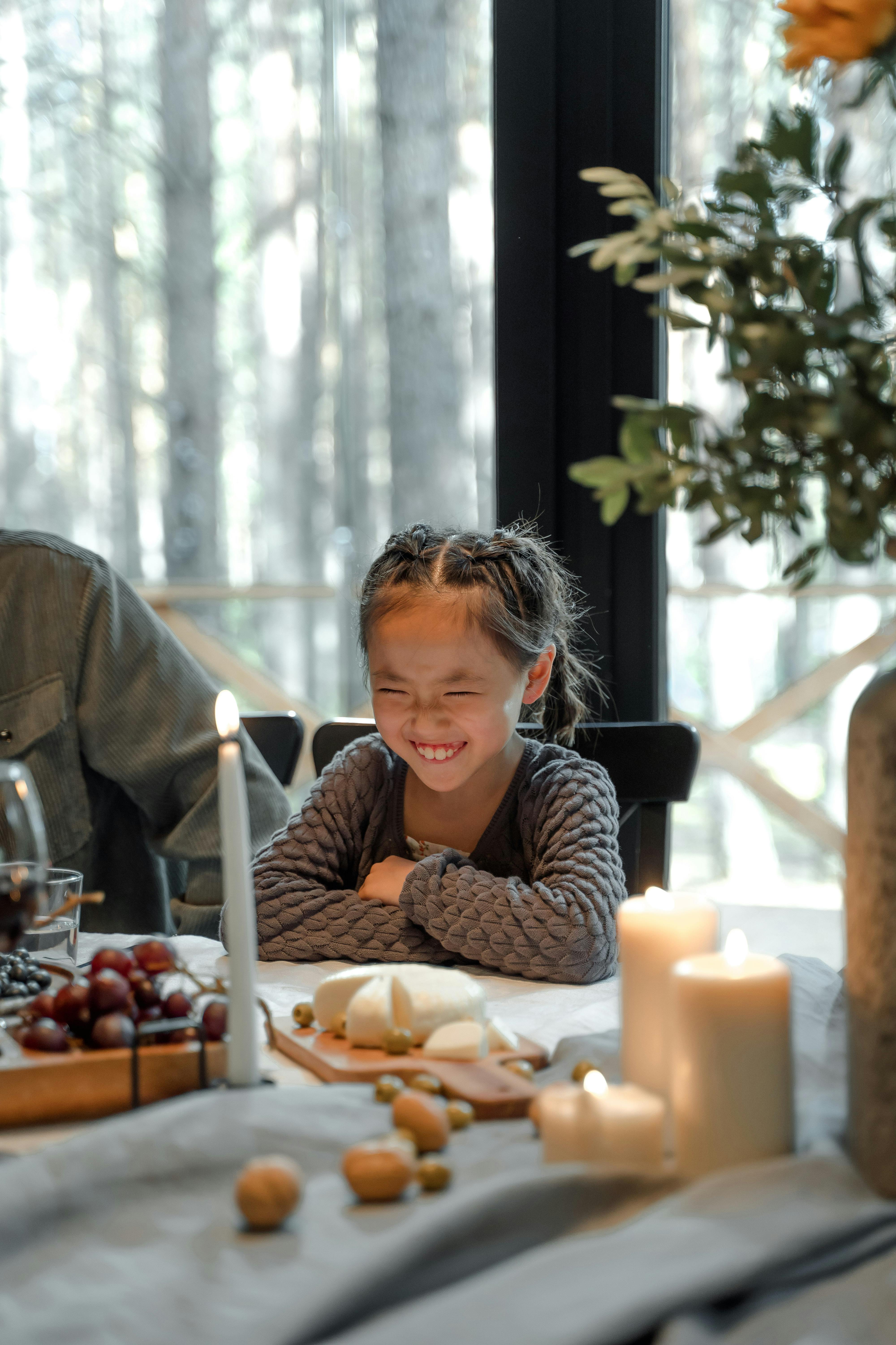 Smiling Girl at Dining Table
