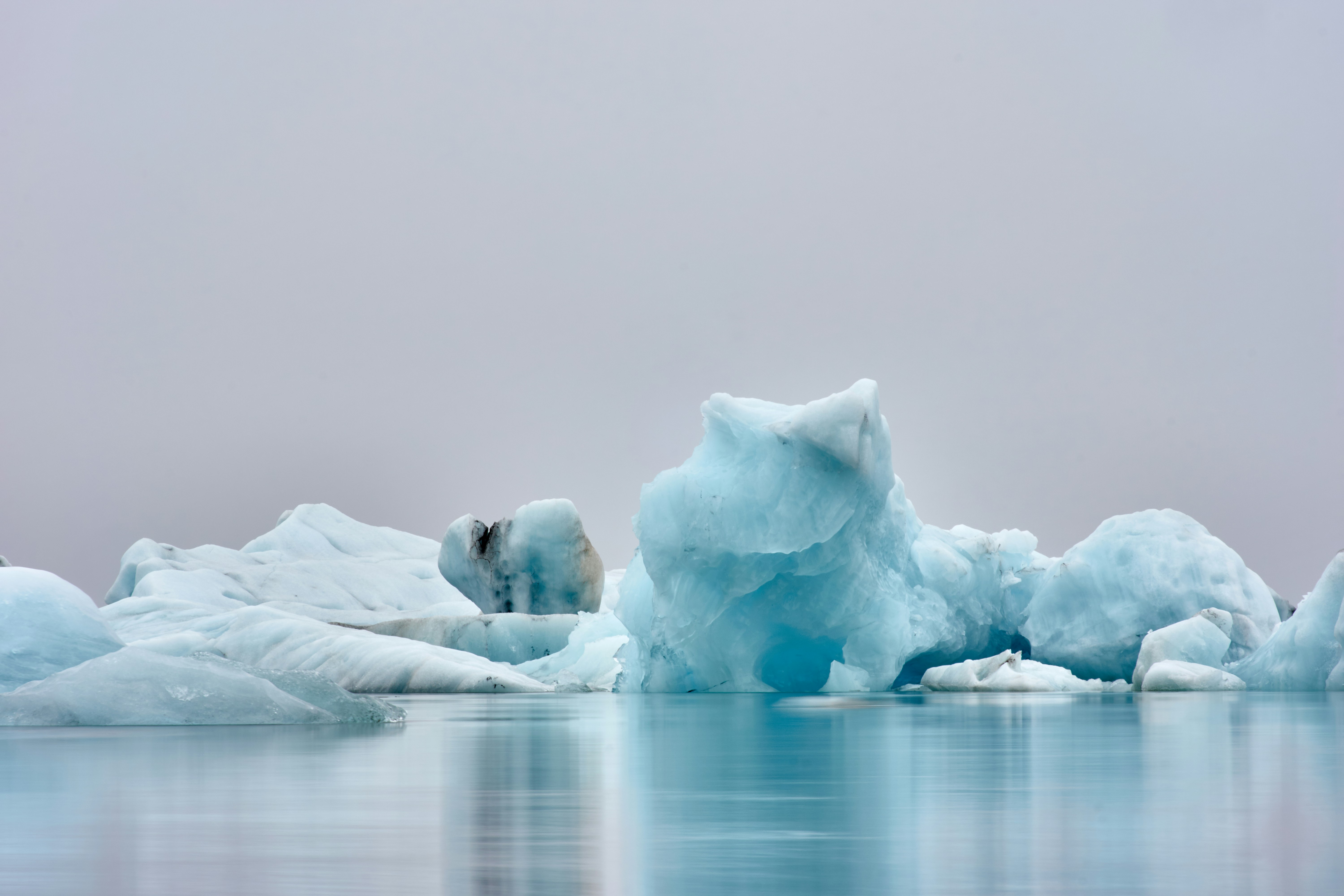 Blue Icebergs on Calm Water