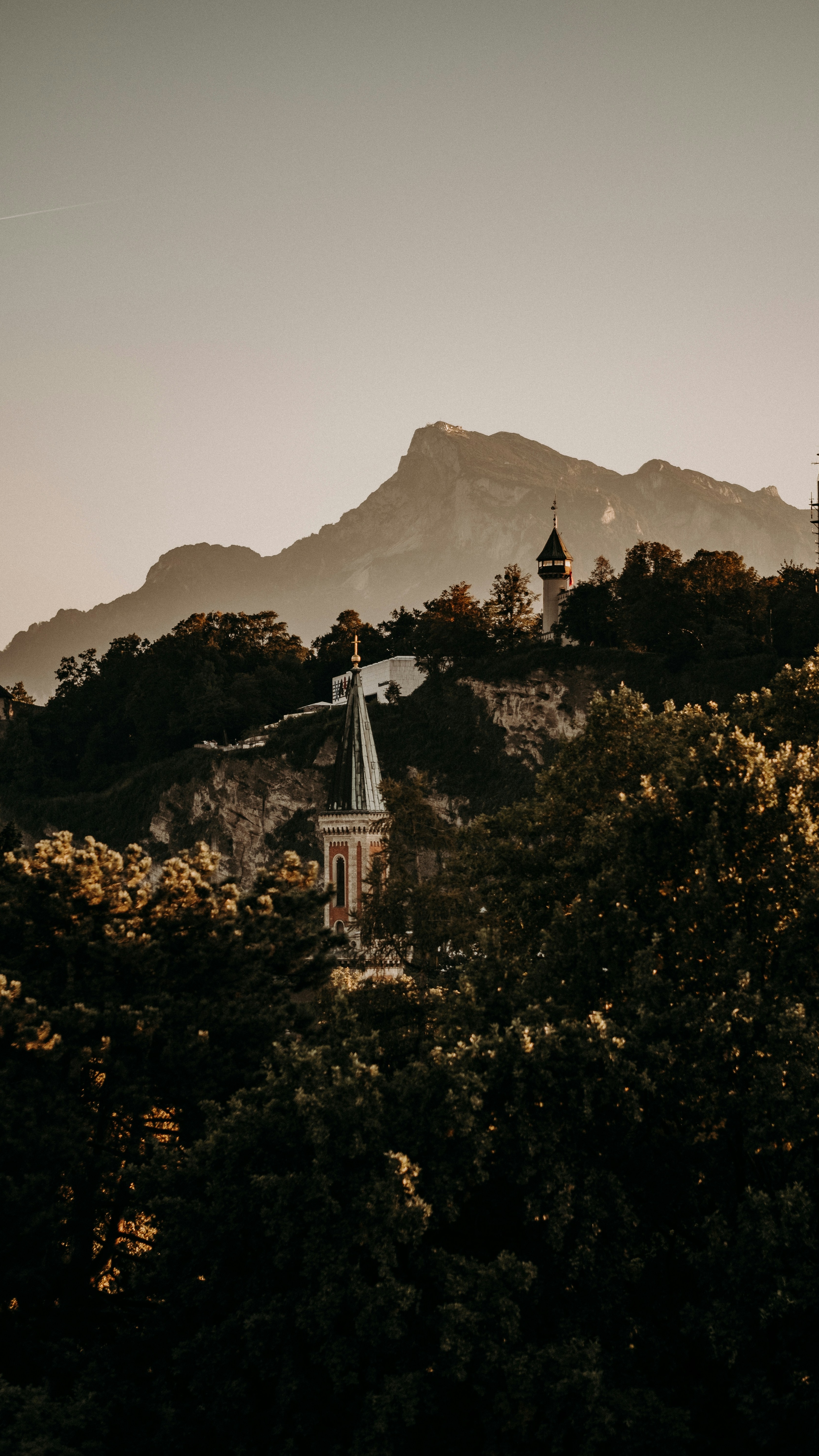 Church Spires Beneath Alpine Mountains