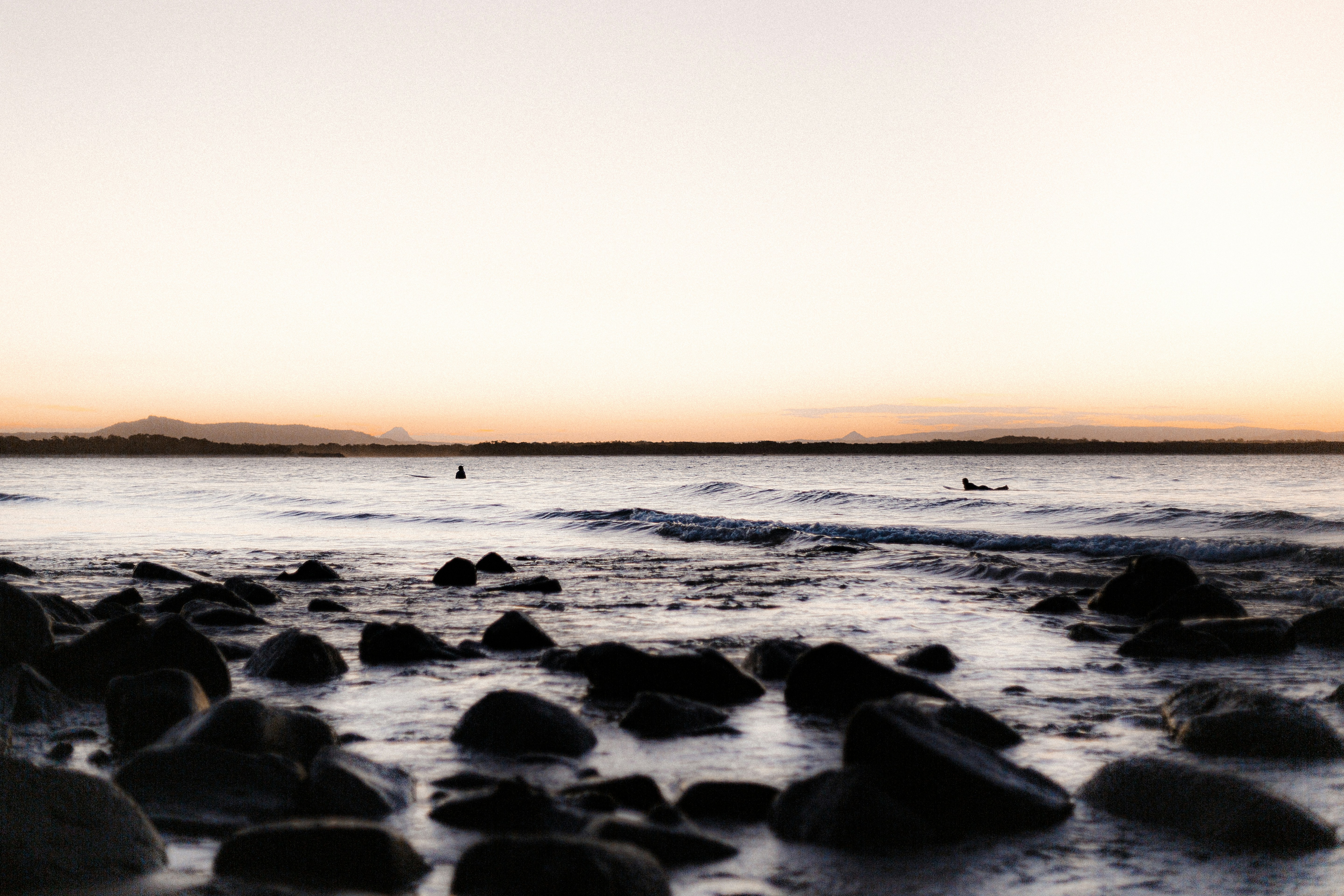 Coastal Seascape at Dawn with Surfers