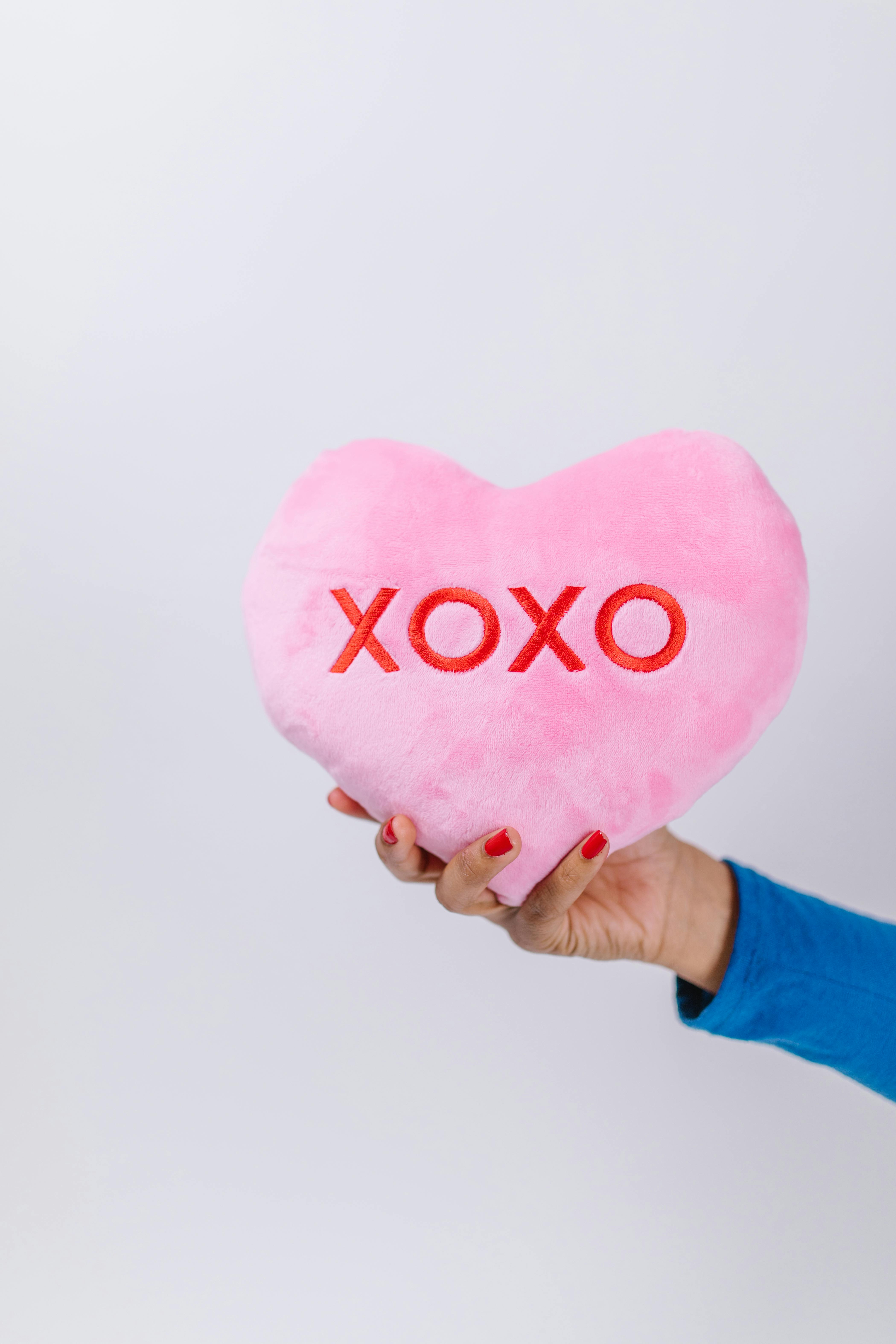 Hand Holding Pink XOXO Heart Pillow