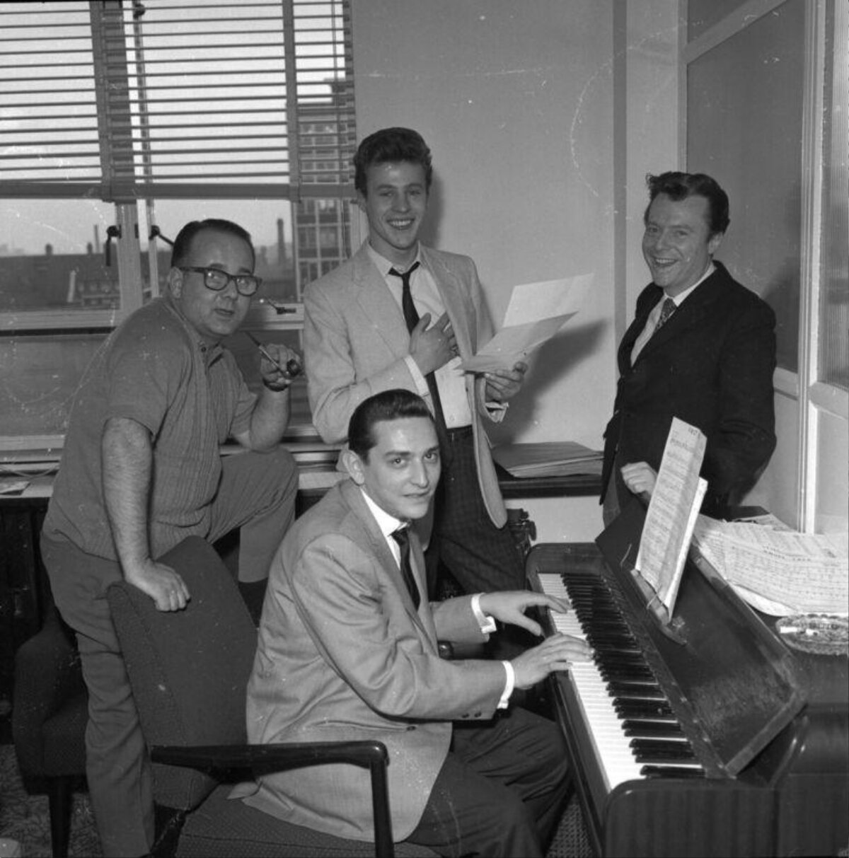 Four Men Gathered Around a Piano