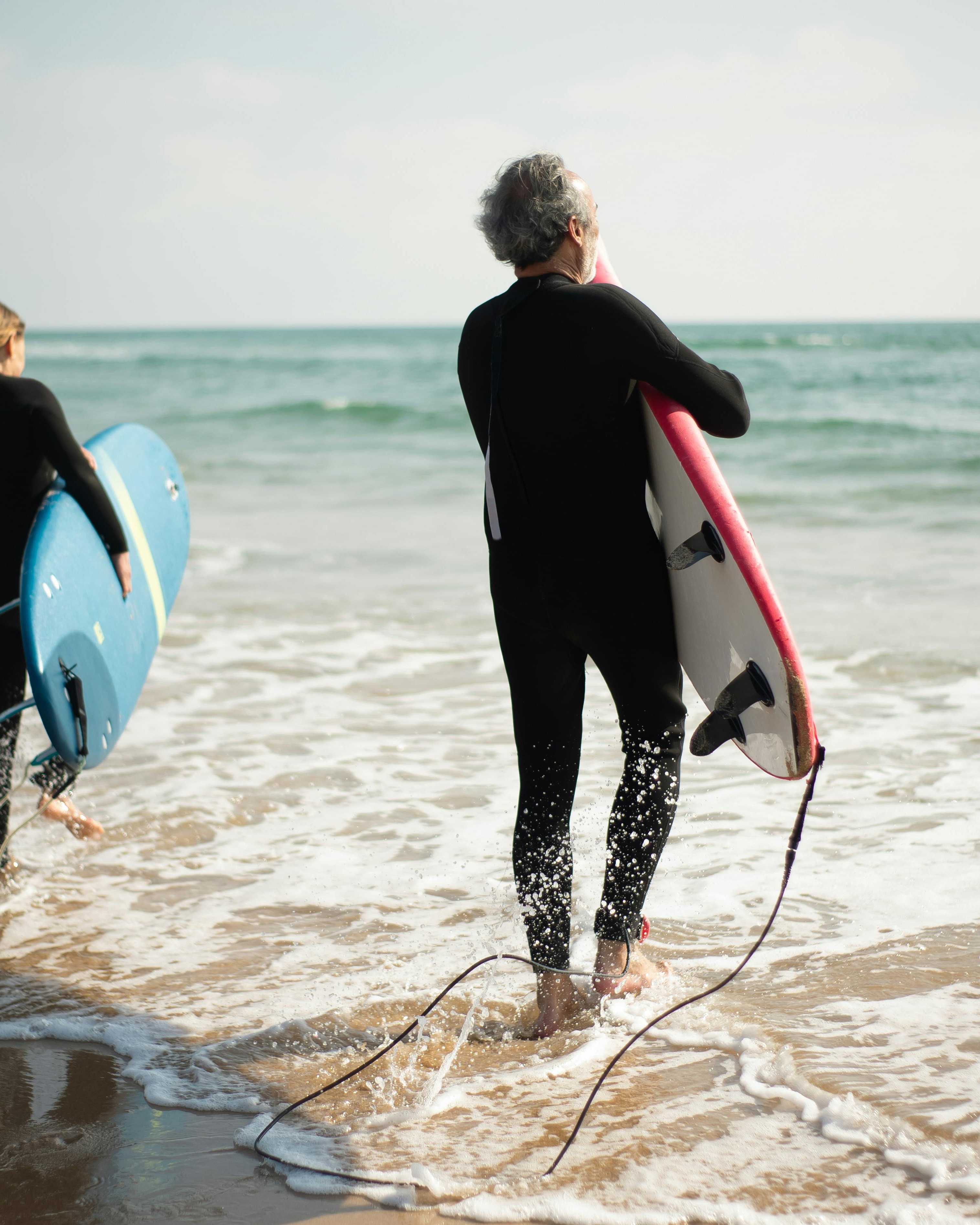 Two Surfers Heading Into Ocean