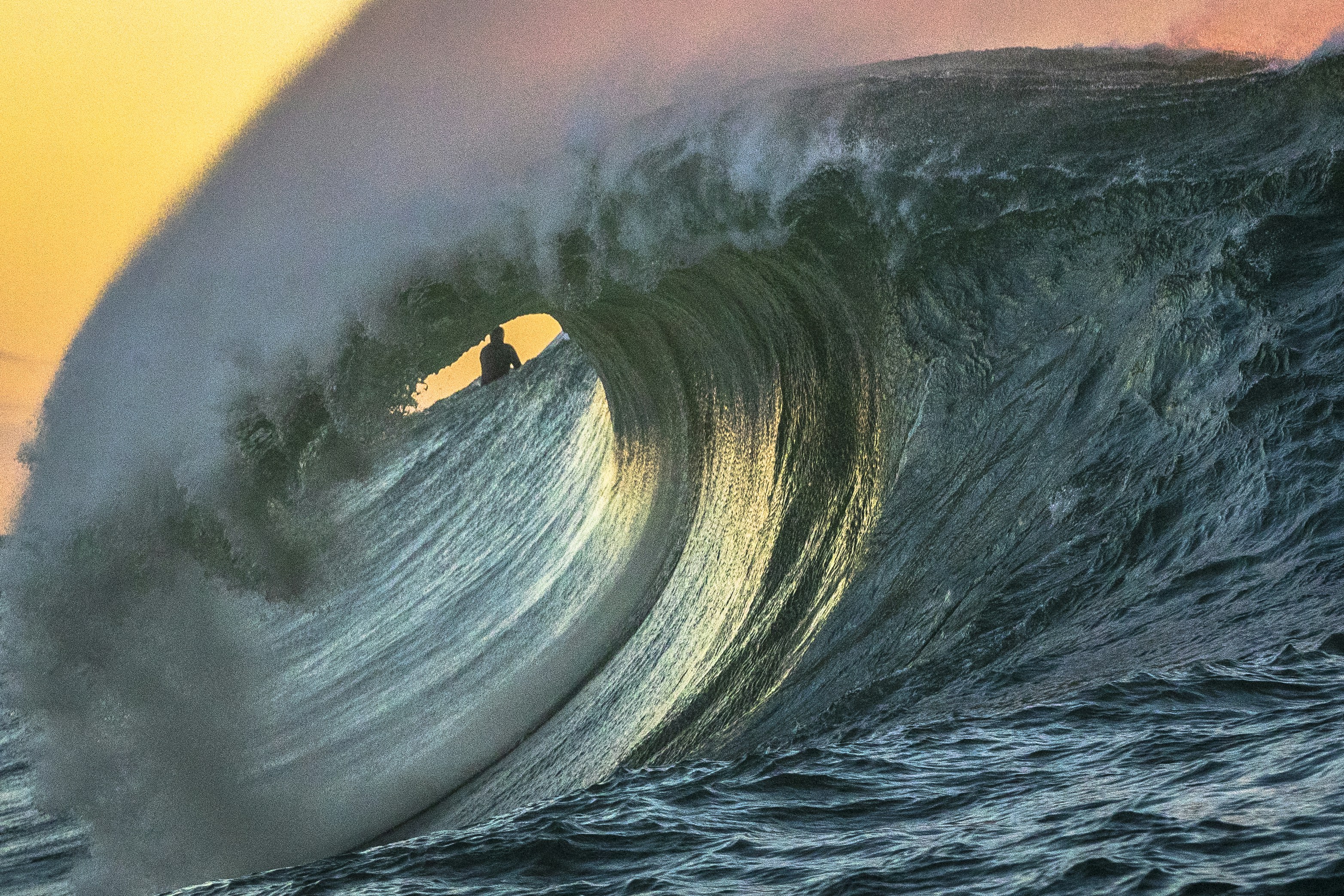 Surfer Riding Giant Wave at Sunset