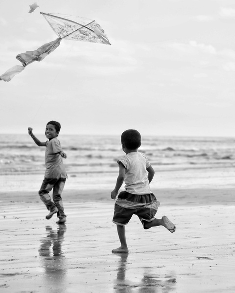 Two Boys Flying Kite on Beach