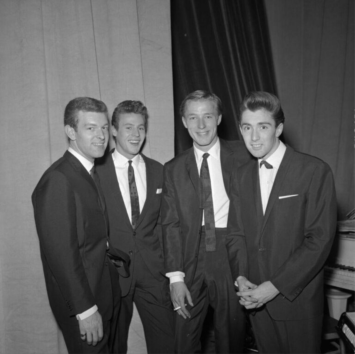 Four Men in Suits Posing Together