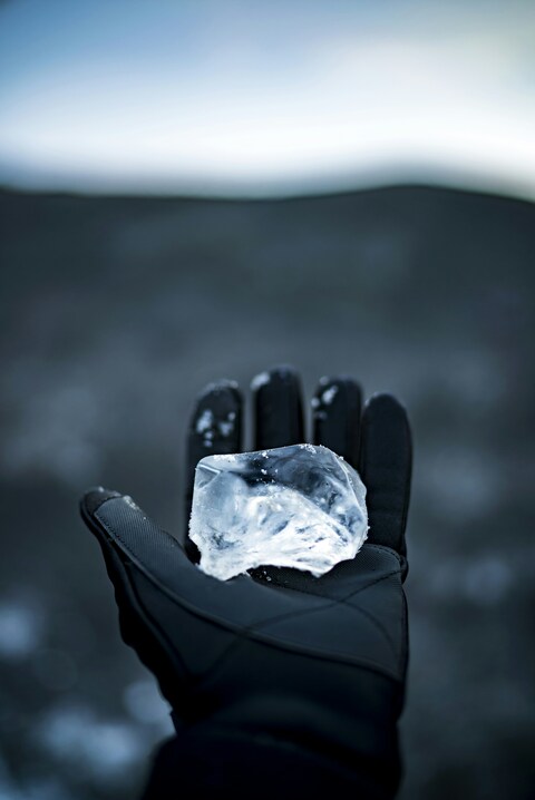 Gloved Hand Holding Ice