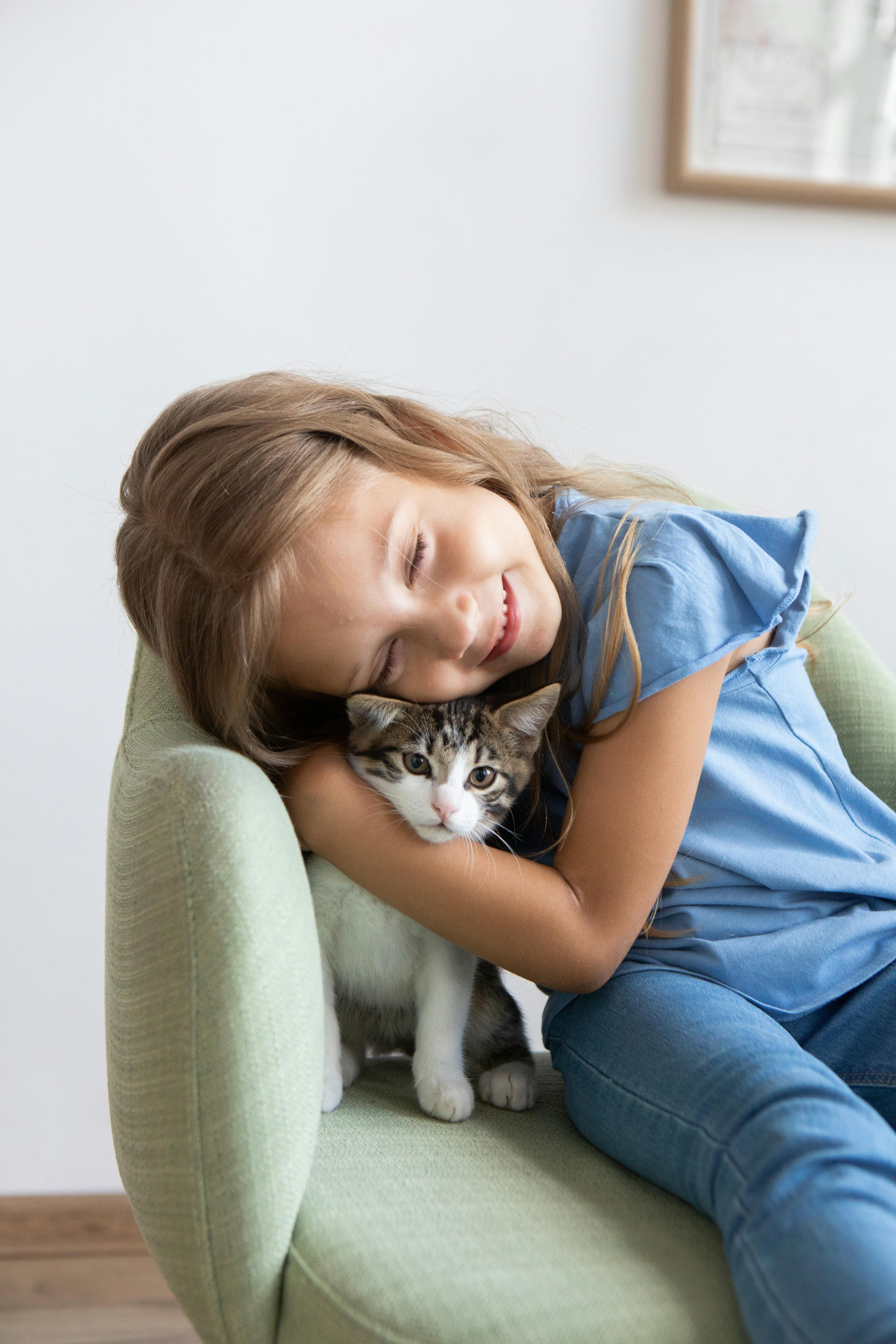Girl Hugging A Kitten