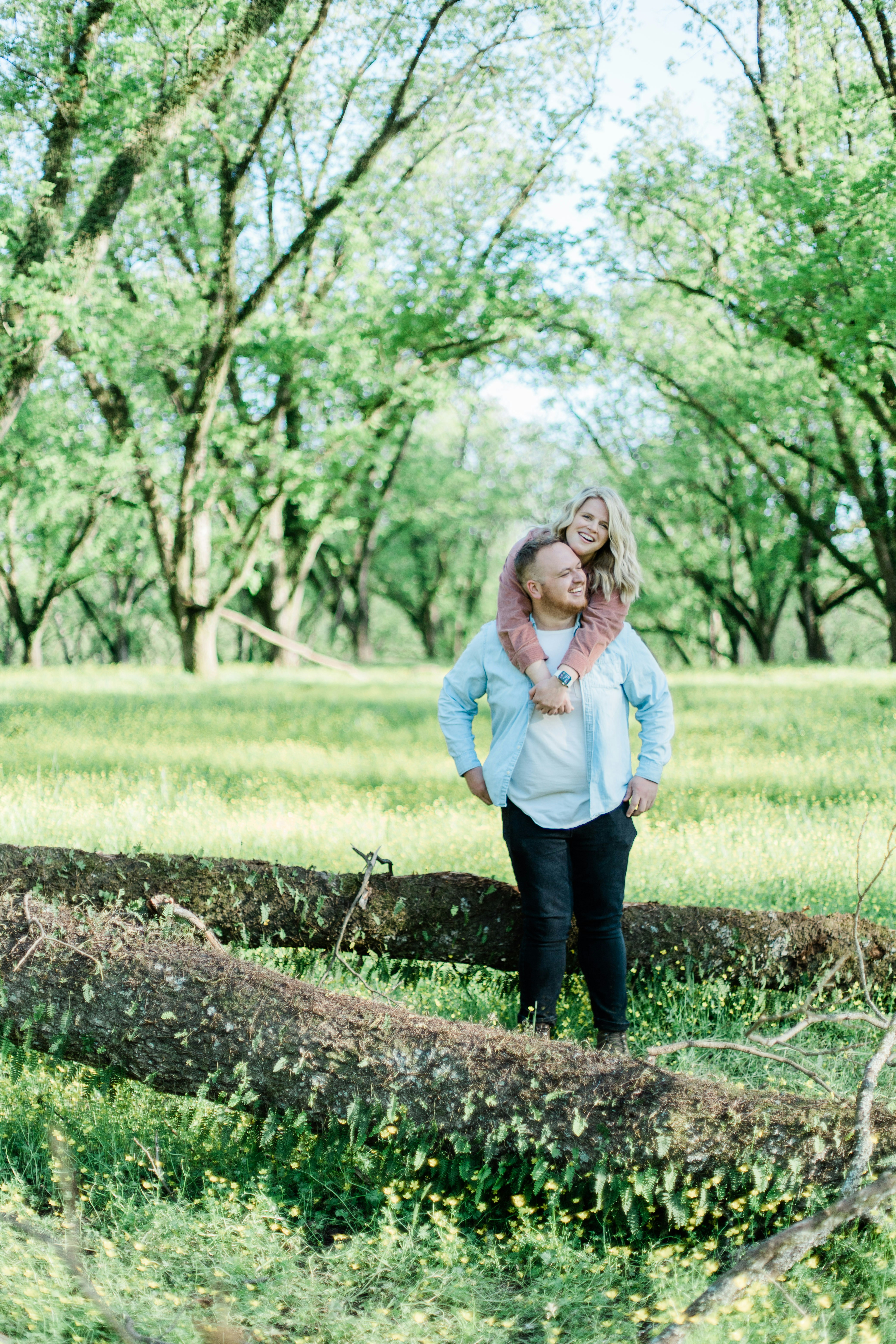 Couple Piggyback in Sunlit Forest Meadow