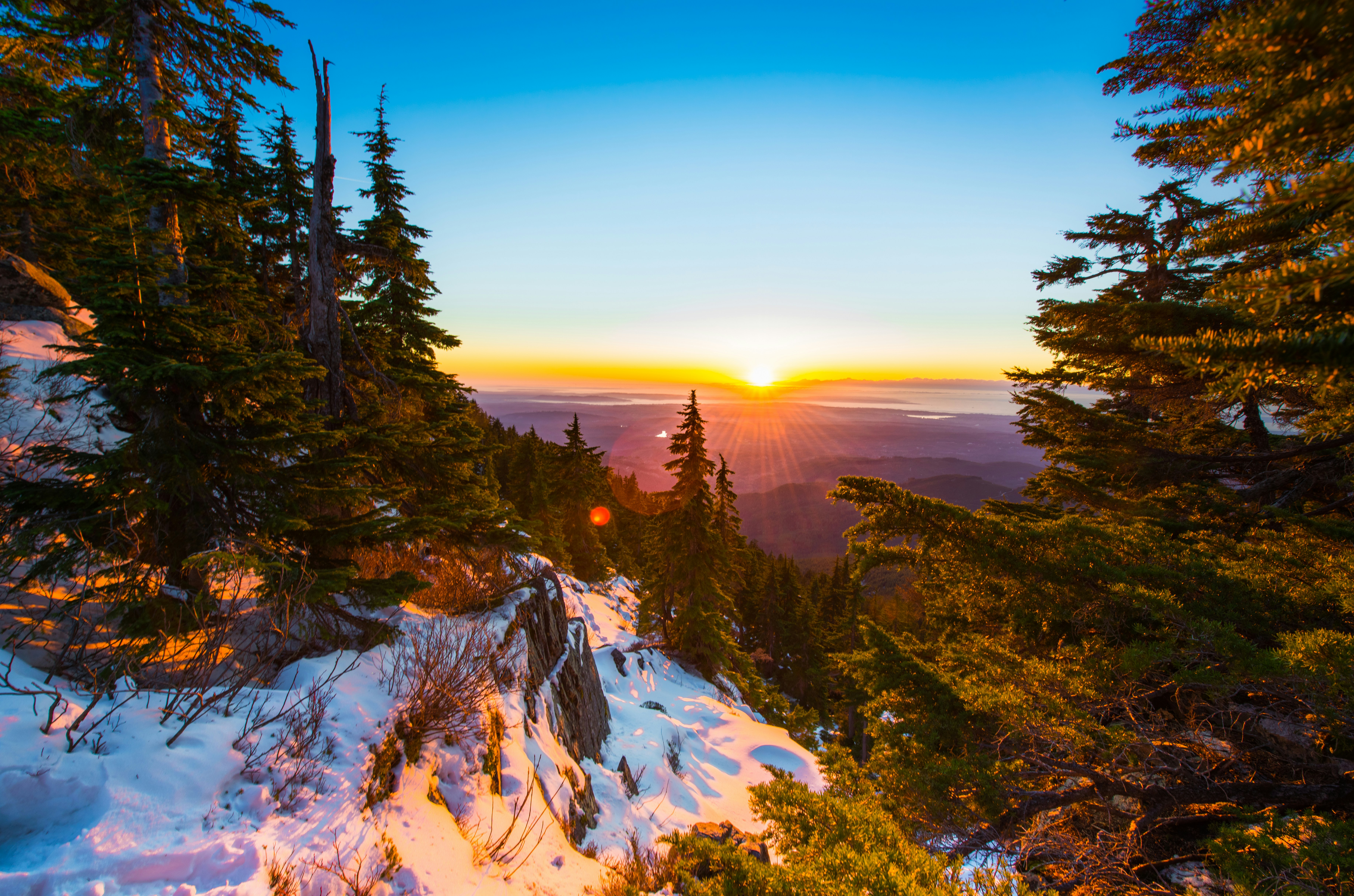 Sunset Over Snowy Mountain Forest