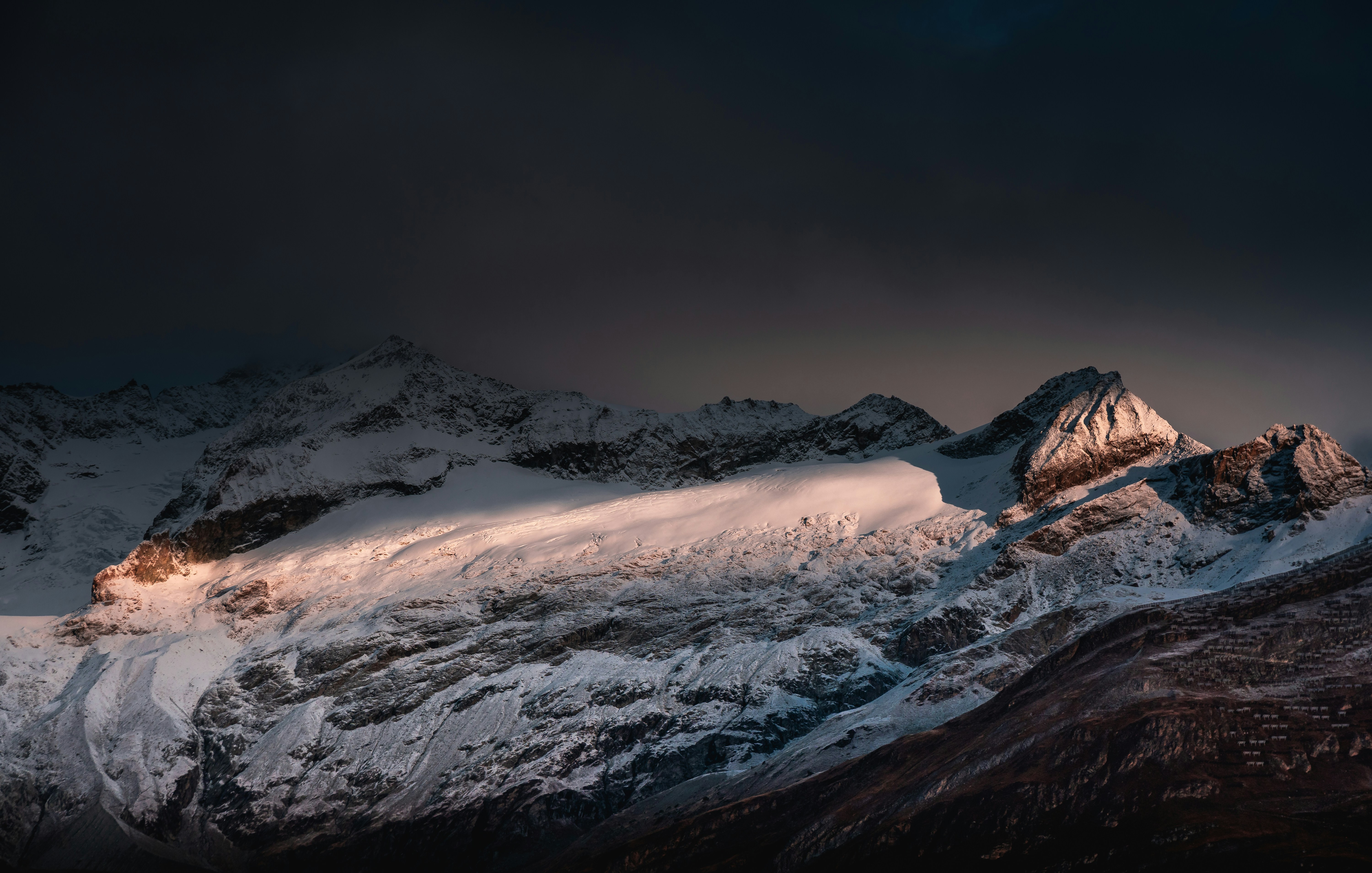 Sunlit Snow-capped Mountain Range
