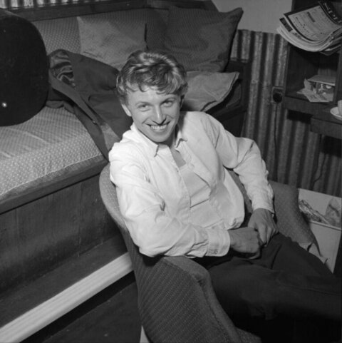 Smiling Person Relaxing in Armchair