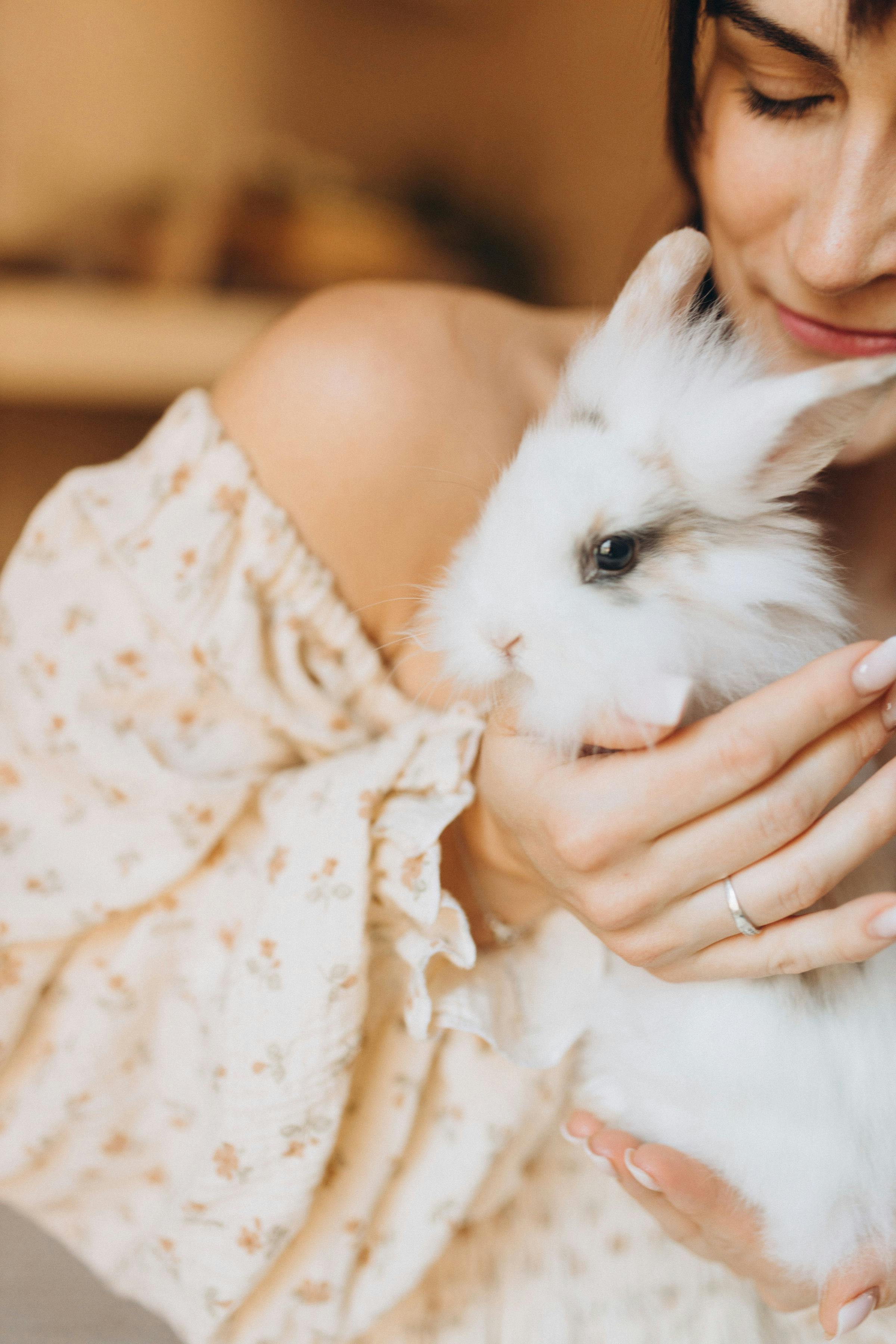 Woman Holding Fluffy White Rabbit