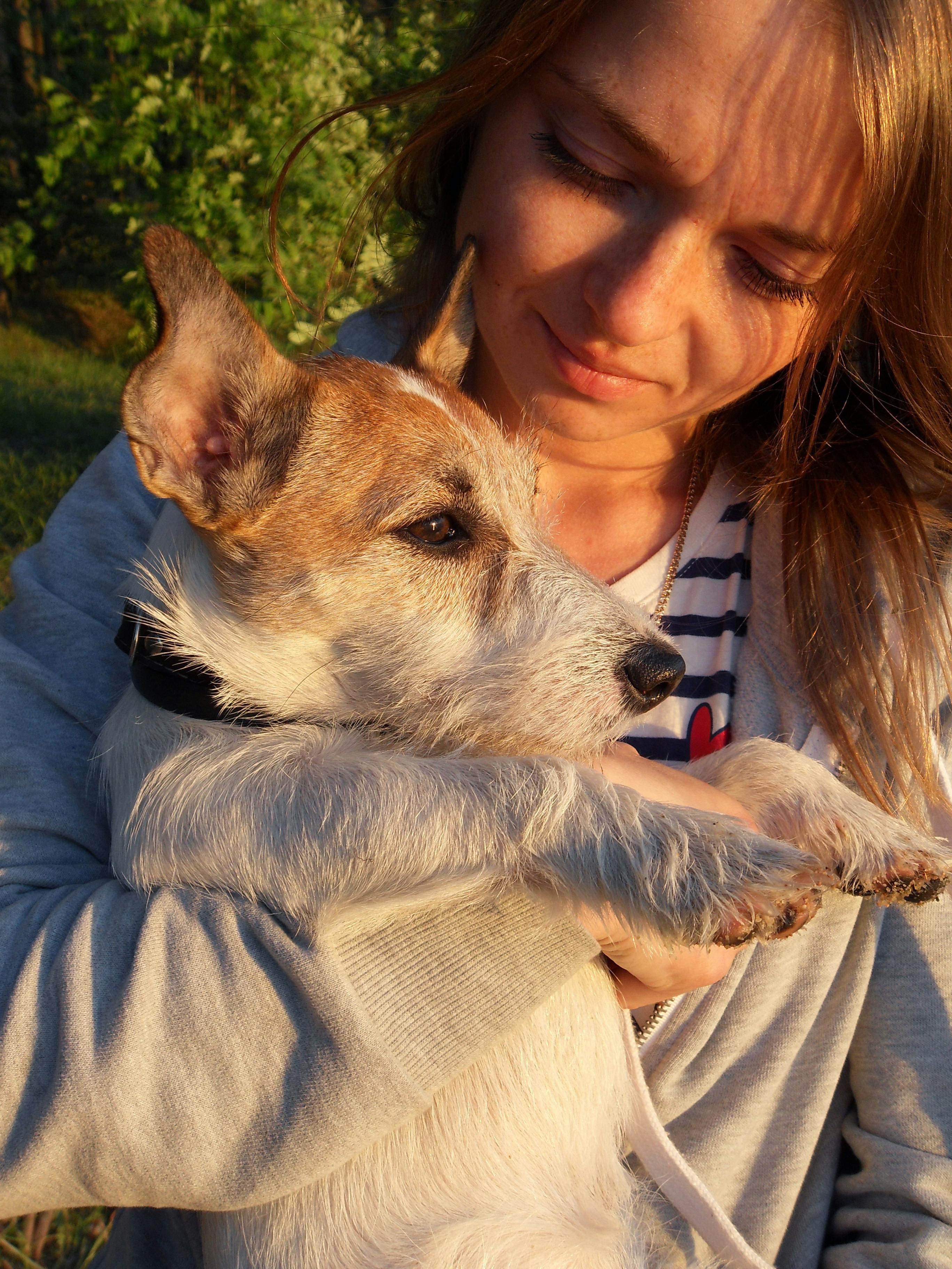 Woman Hugging Dog Outdoors