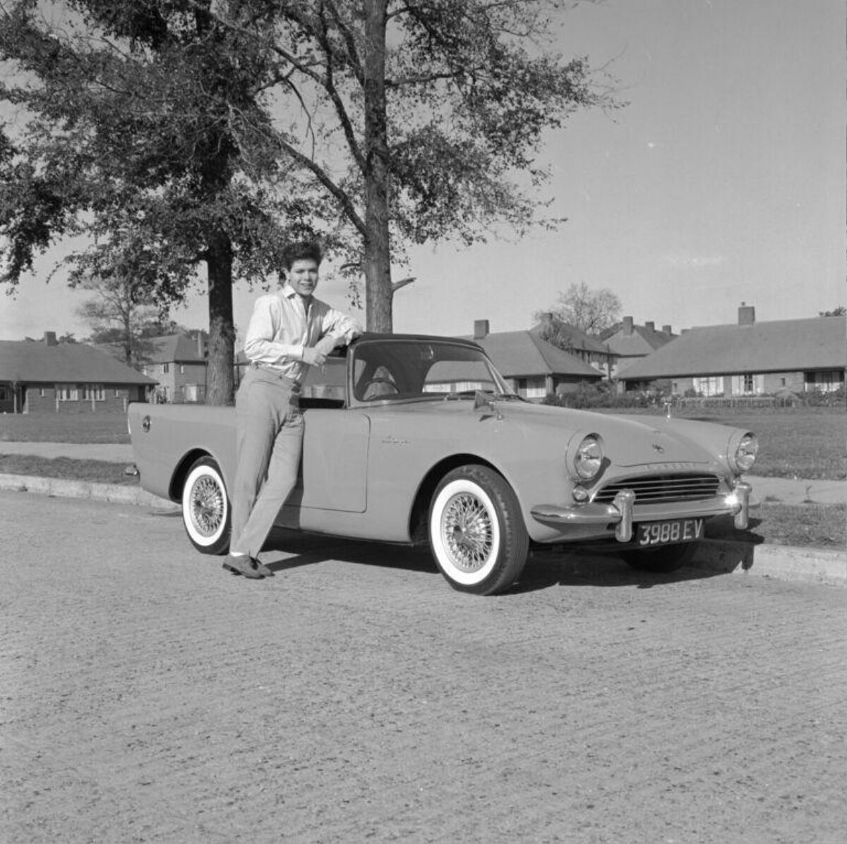 Man Leaning on Vintage Convertible Car