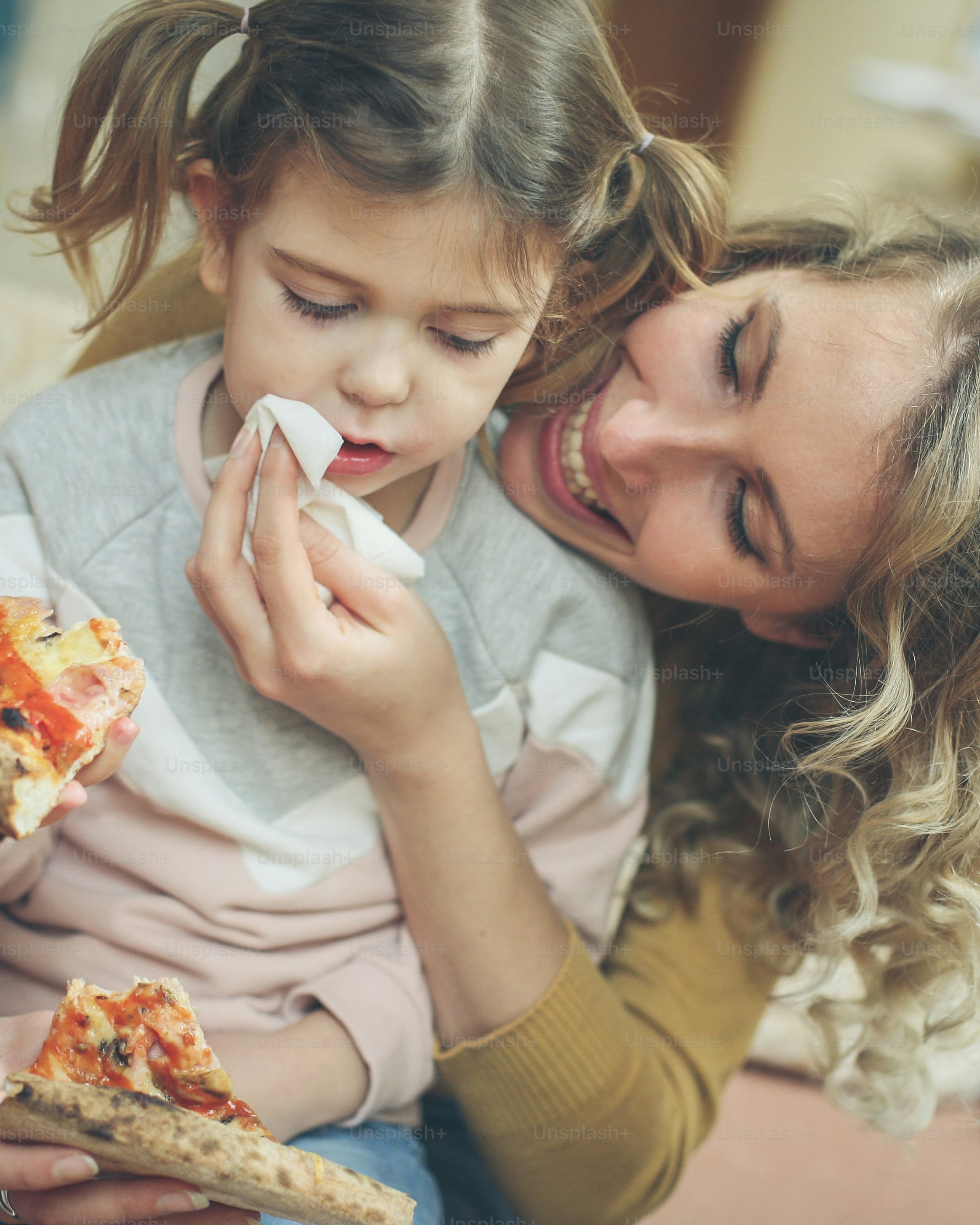 Mother and Daughter Eating Pizza