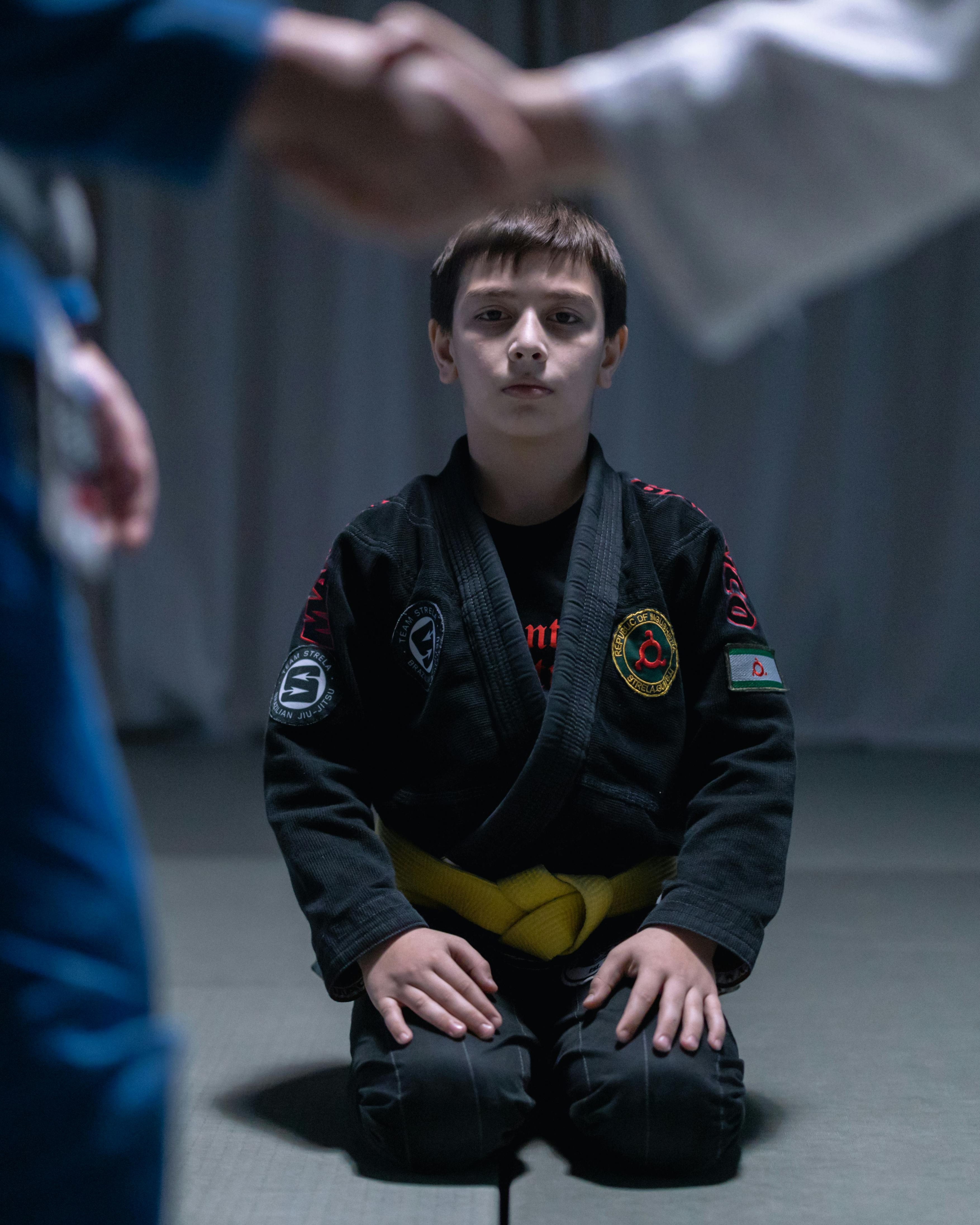 Young Jiu-Jitsu Student Kneeling on Mat