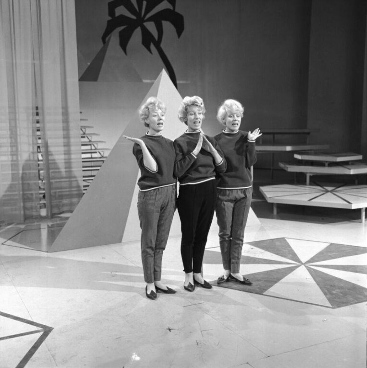 Three Singers Performing On Stage