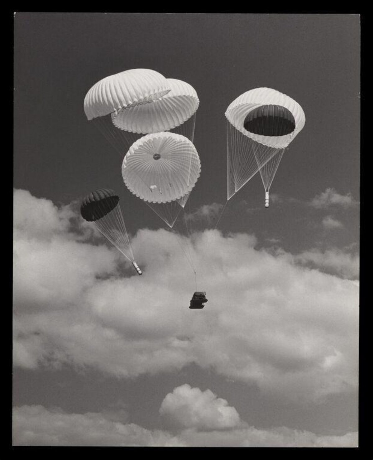 Multiple Parachutes Airdropping Cargo