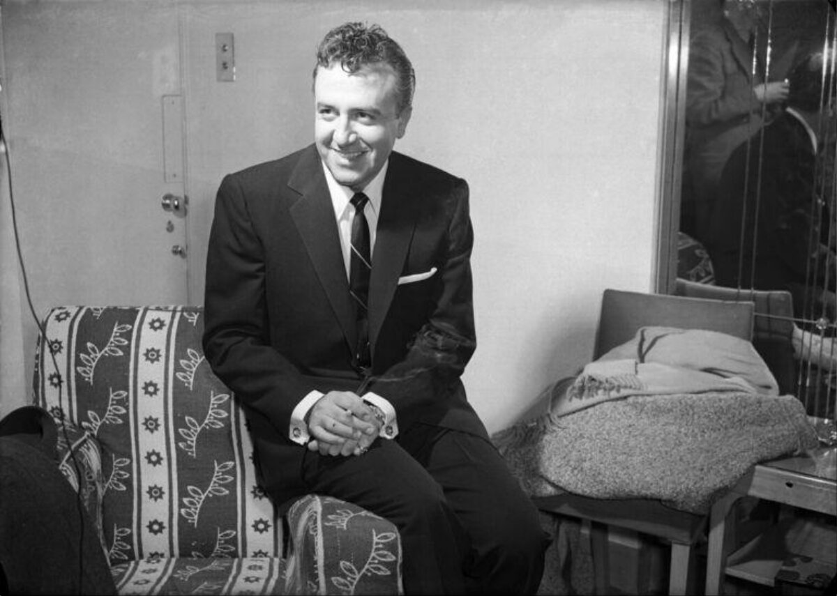 Smiling Man In Suit Seated On Sofa