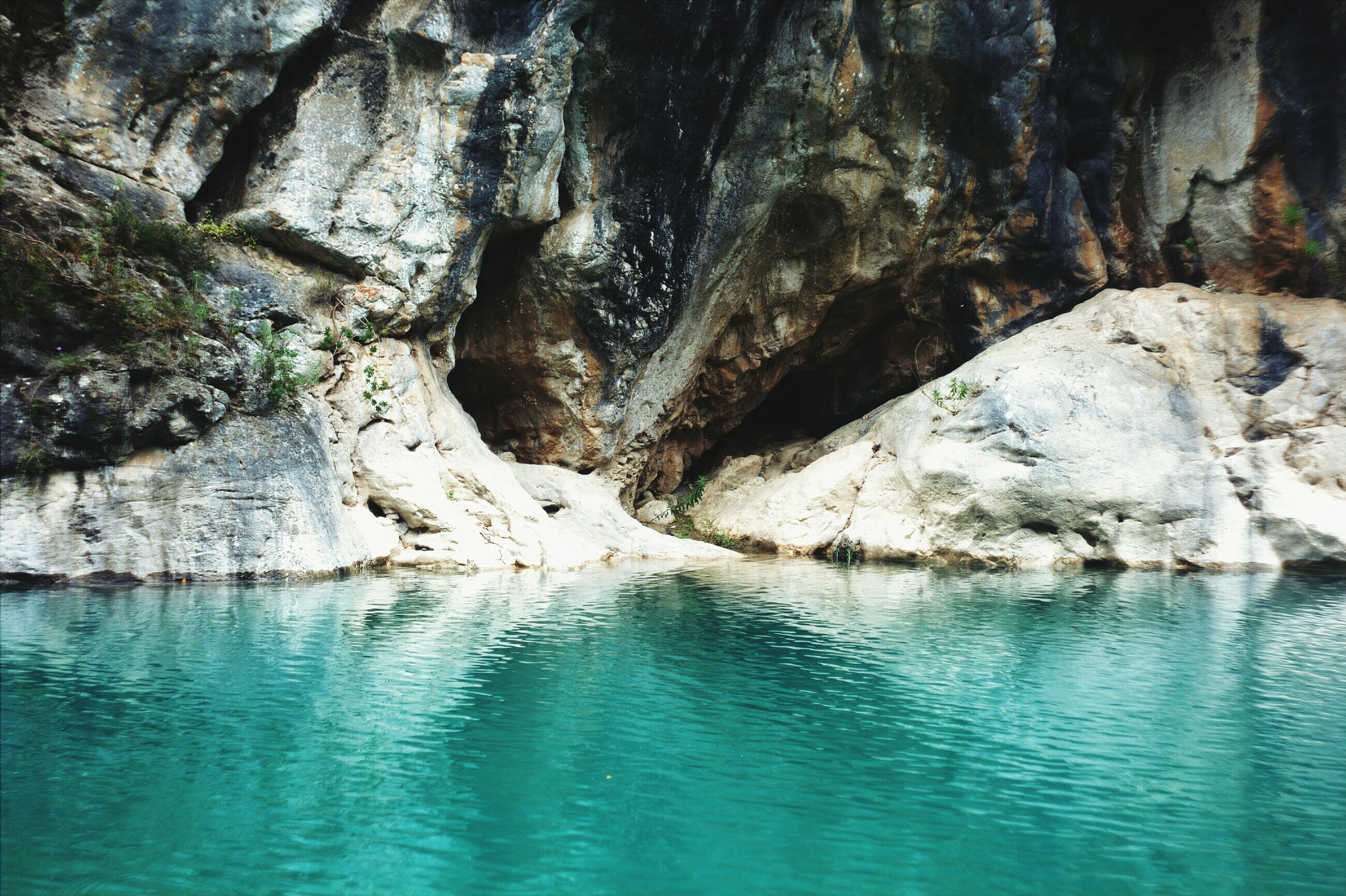Rocky Cave by Turquoise Water