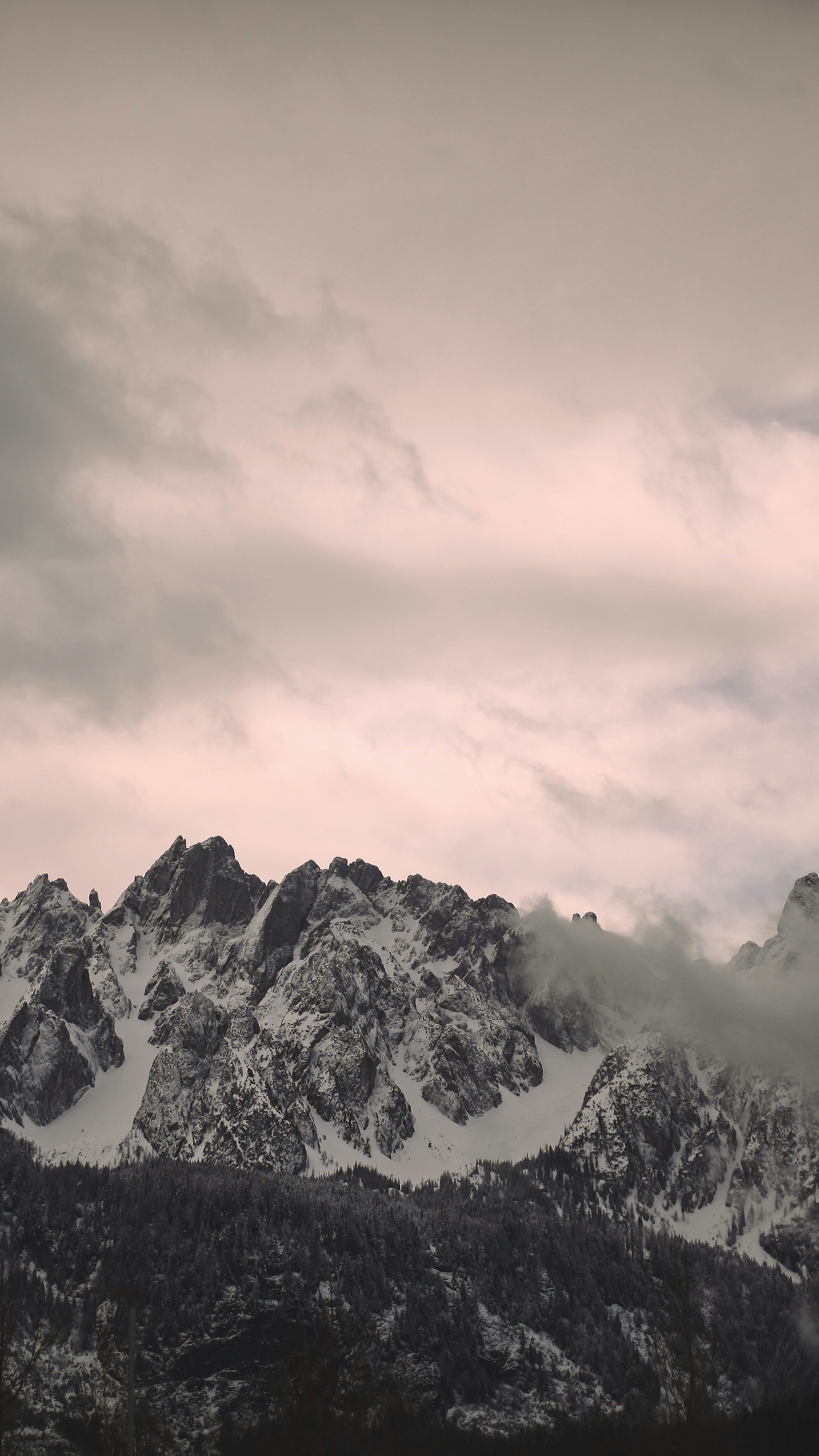 Snow-Capped Mountains Under Cloudy Sky