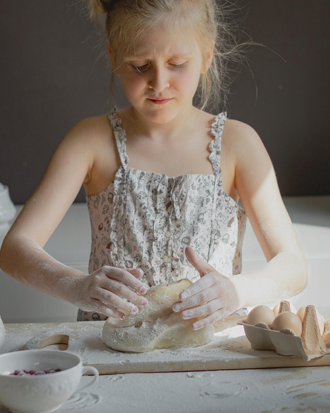 Young Girl Kneading Dough