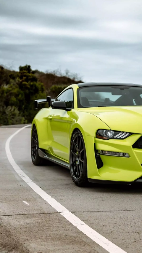 Neon Yellow Sports Car on Winding Road